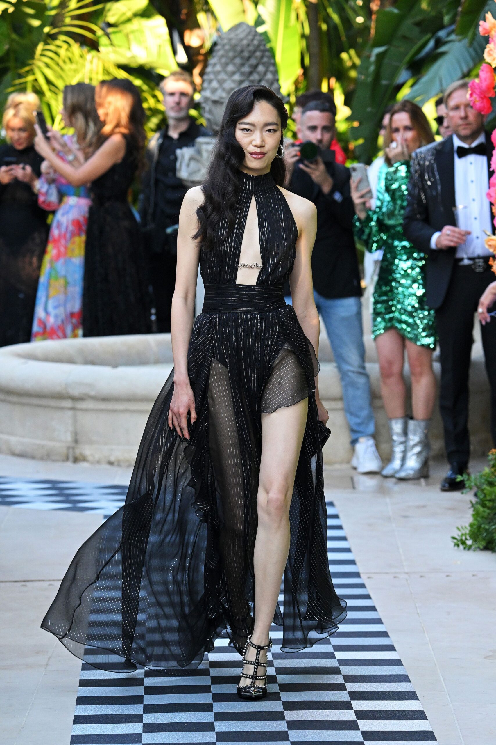 black pleated maxi gown with strappy shoes