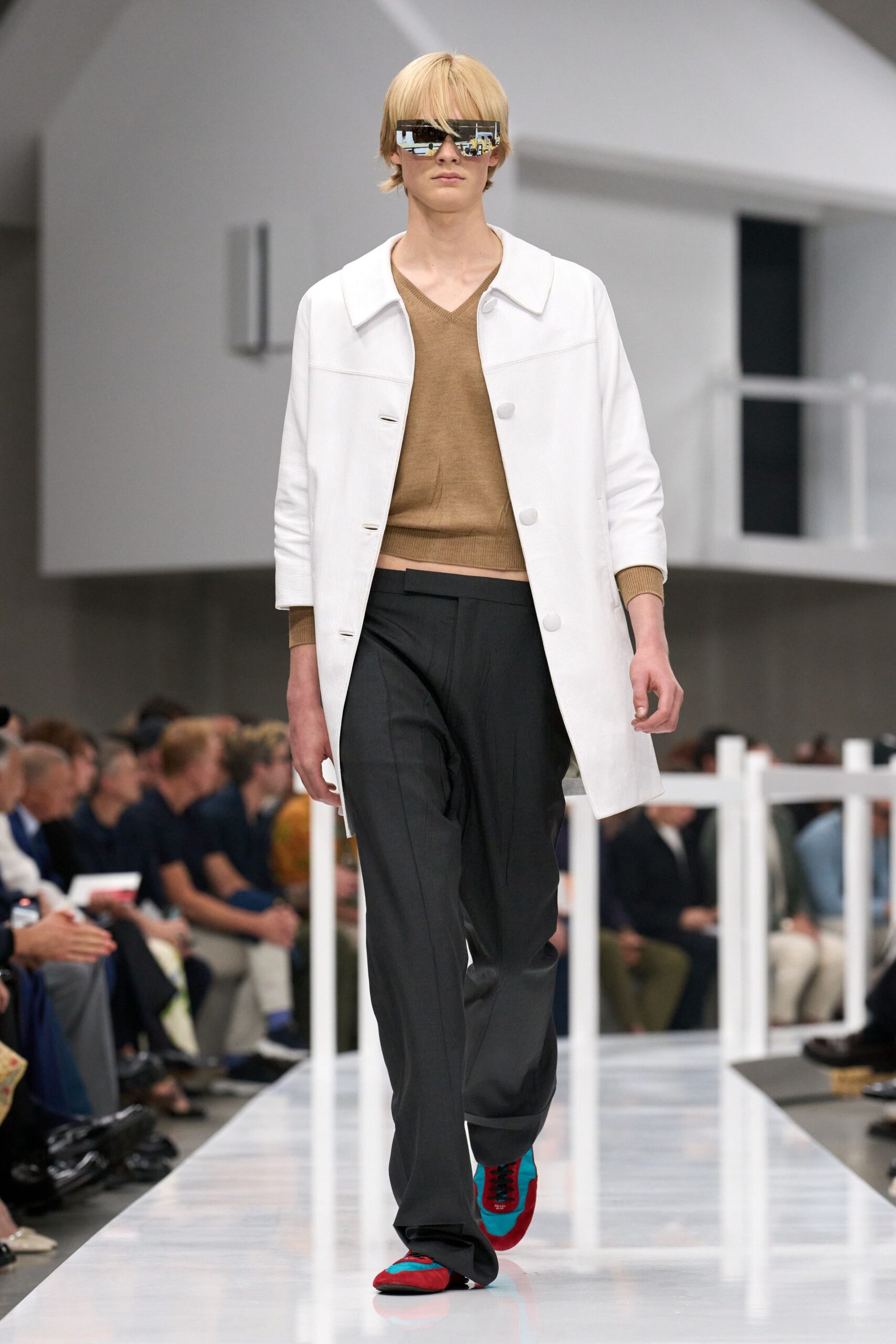 white coat brown top gray pants