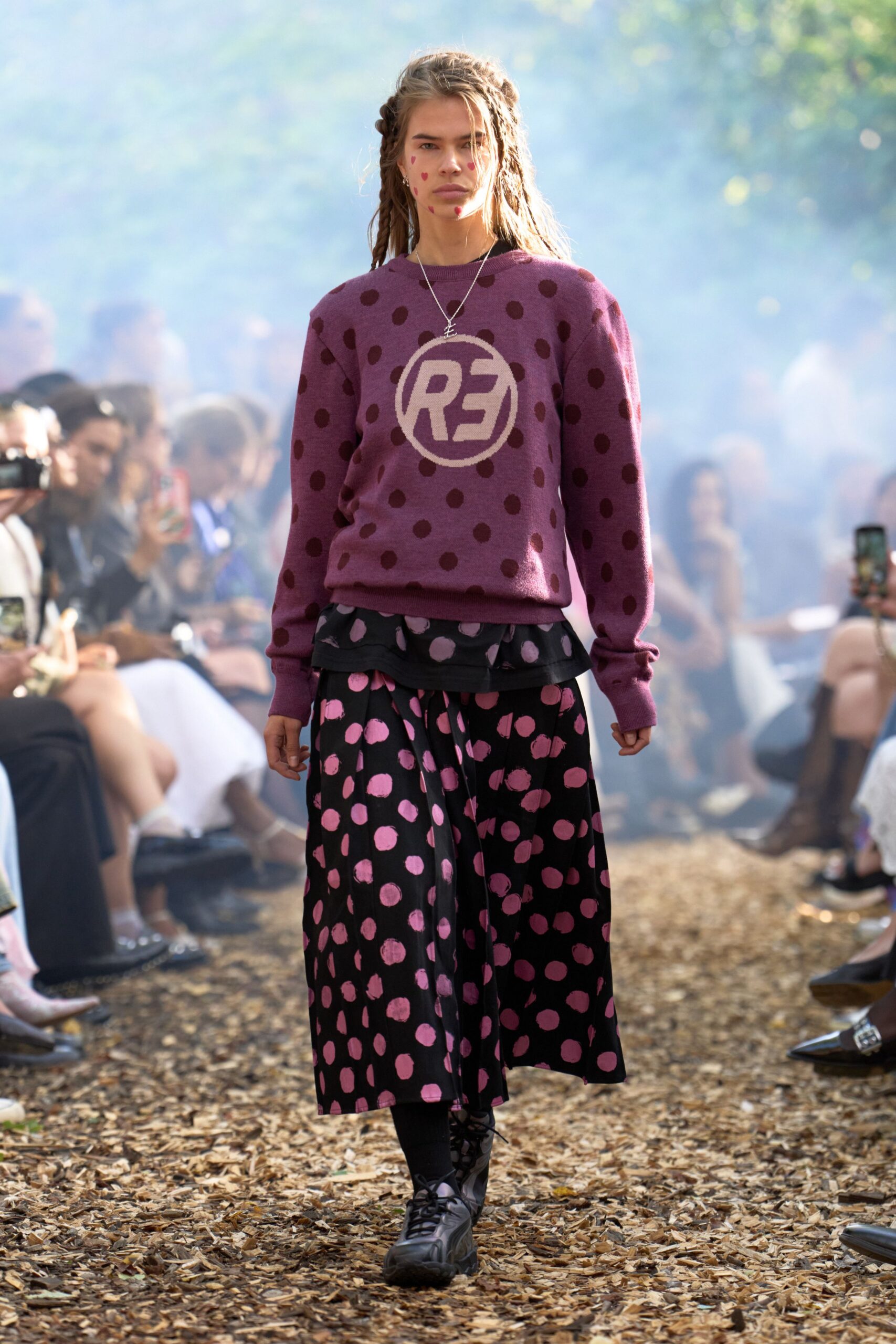 purple polka-dot sweater and black skirt