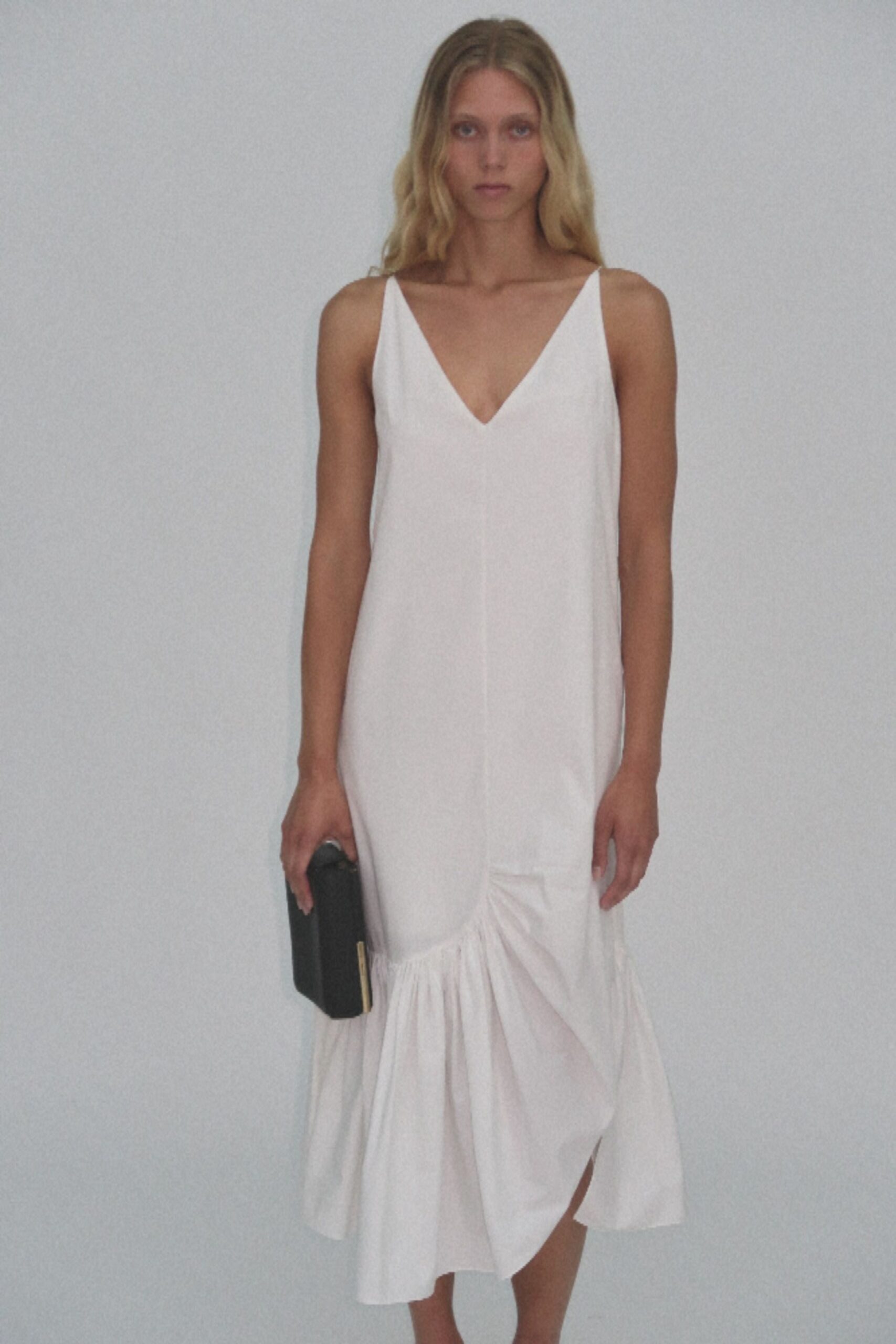 white fitted midi dress with clutch