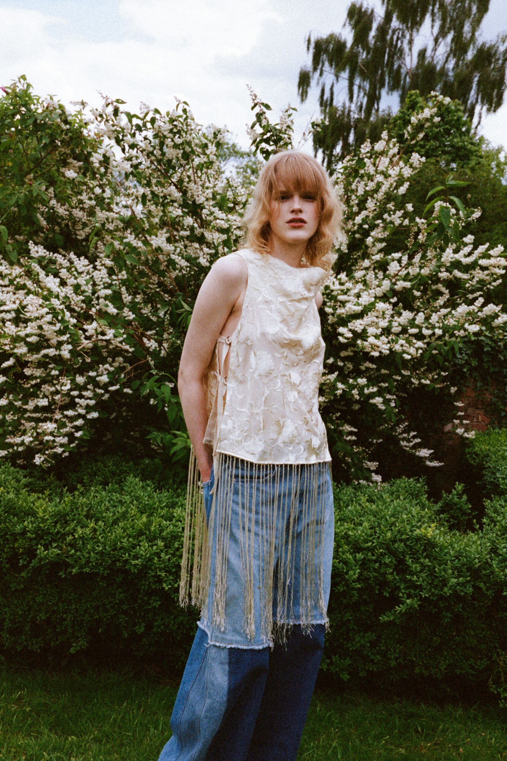 ivory silk sleeveless top and blue denim pants