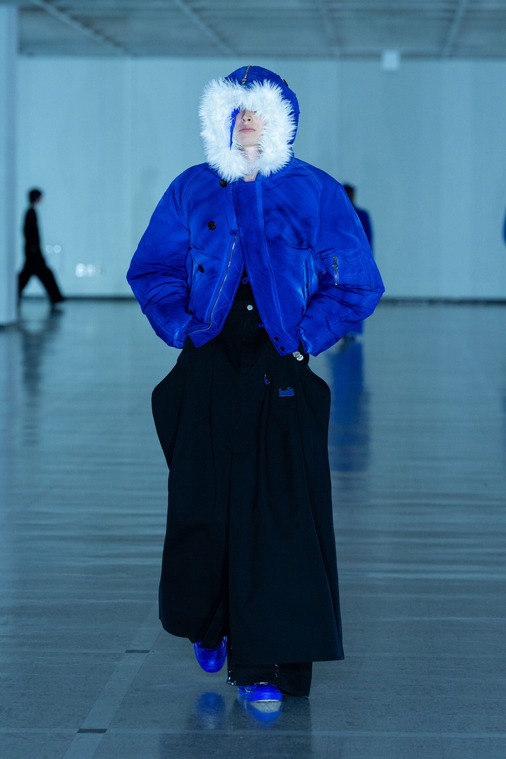 blue faux-fur hooded jacket with black wide-leg pants