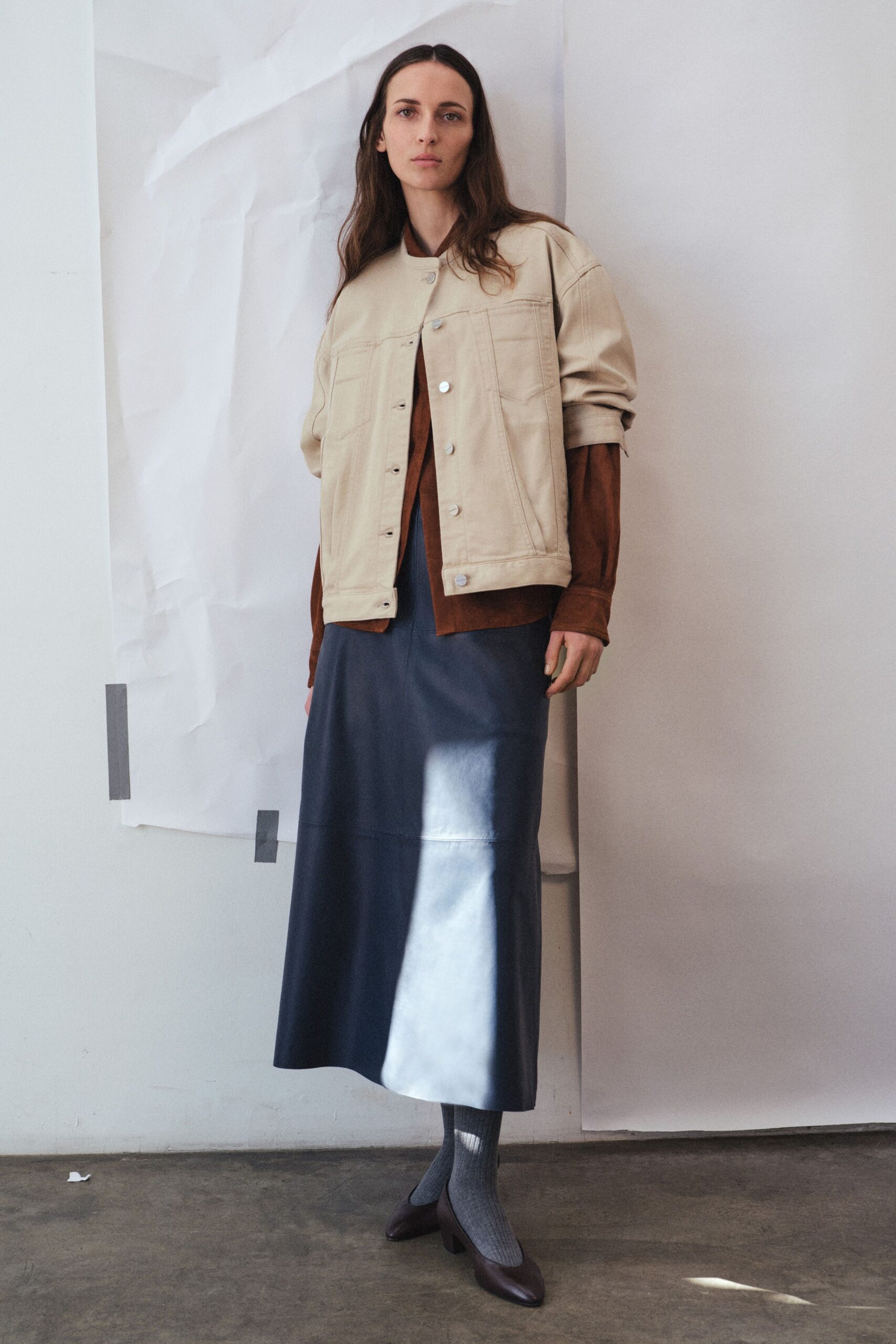 beige jacket brown top blue skirt