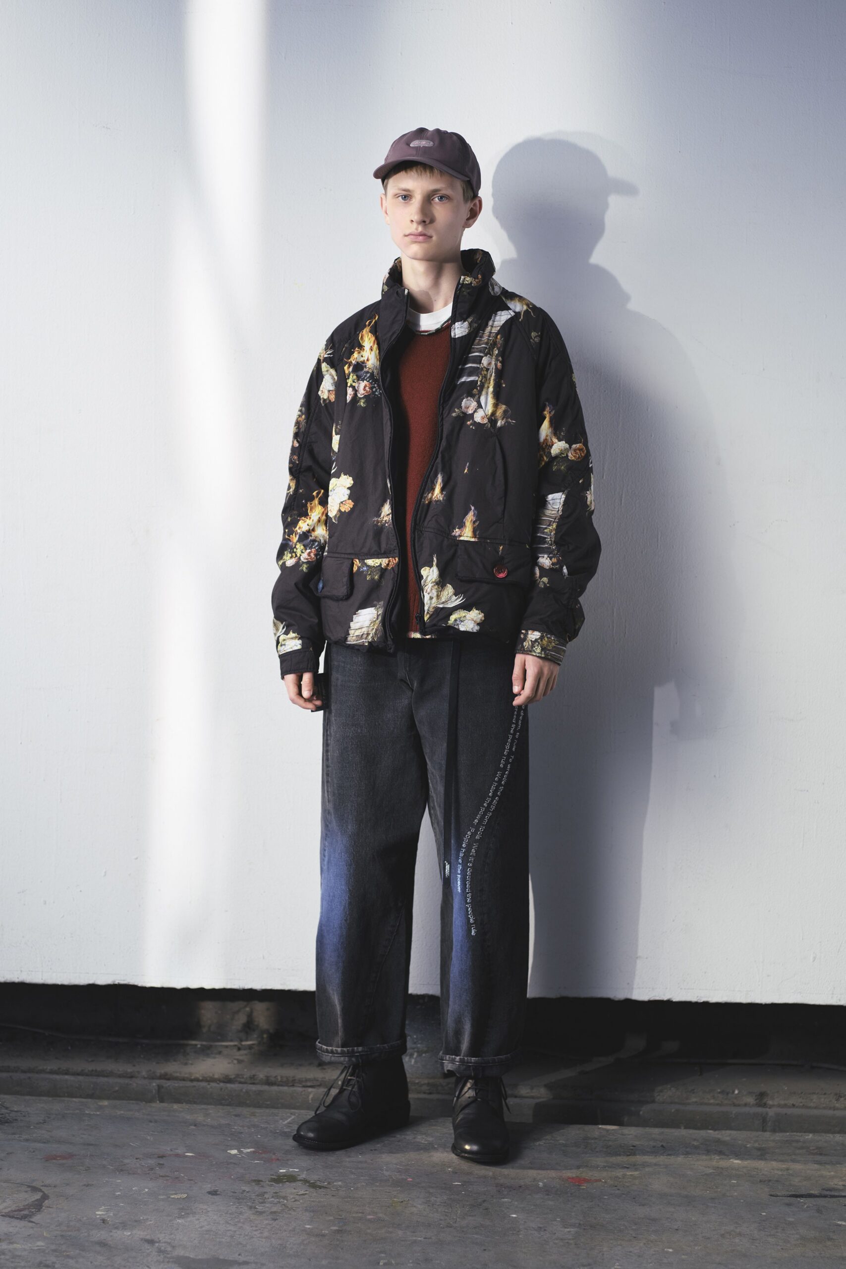 black multi-printed jacket with red sweater