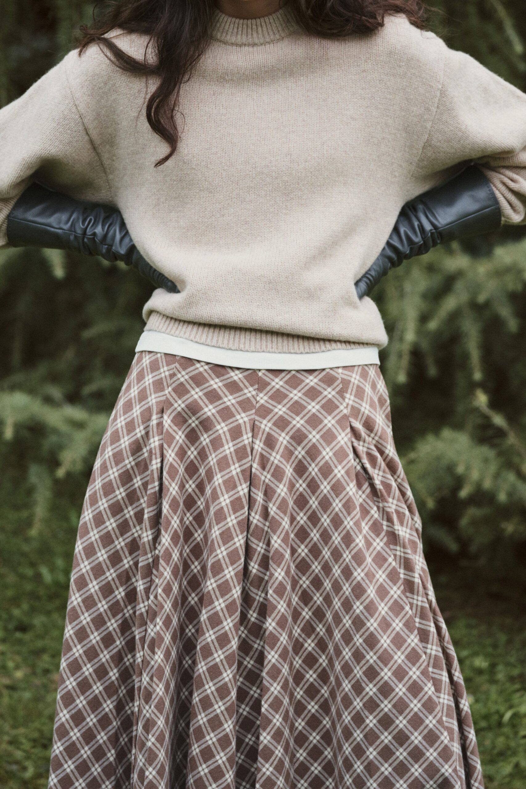 beige wool sweater with brown checked skirt