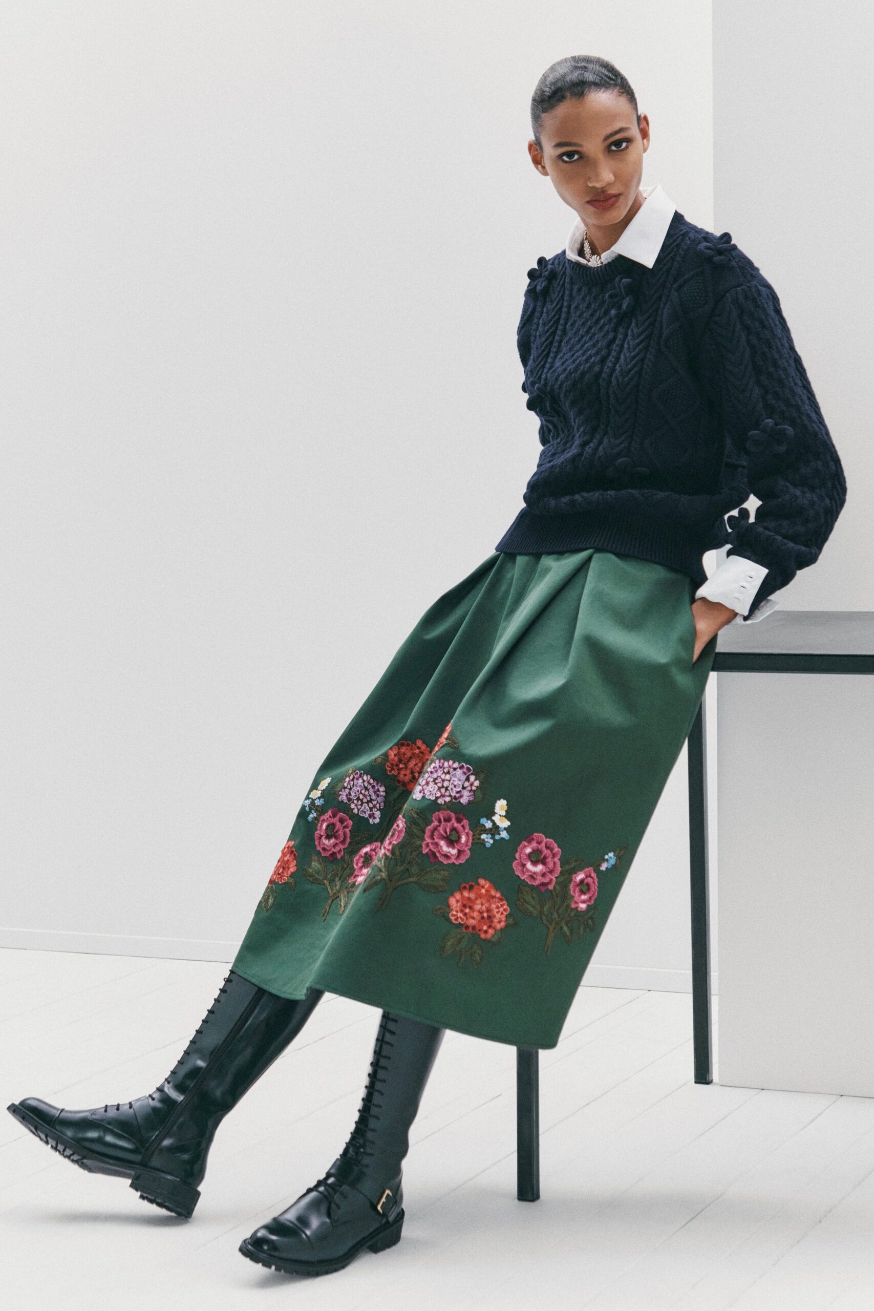 black sweater green embroidered skirt