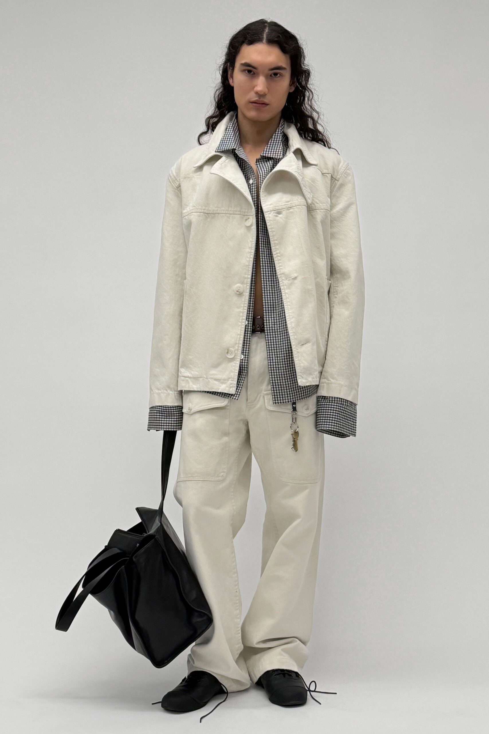 white jacket black checked shirt beige pants
