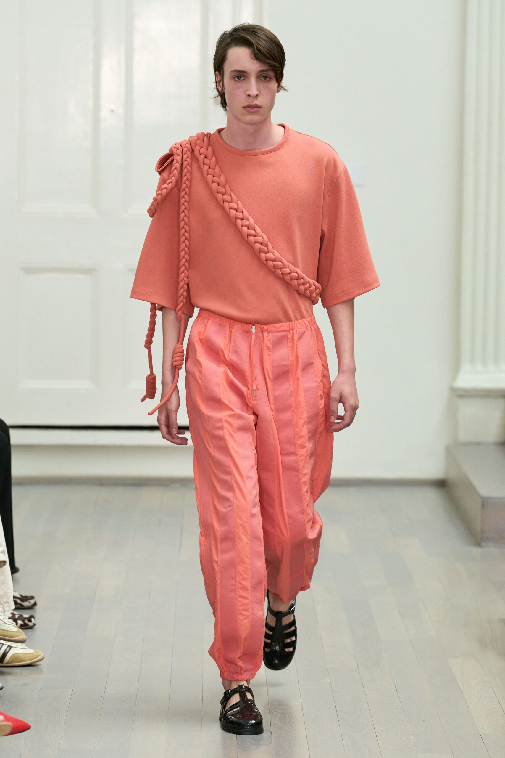 coral top and pants with black shoes