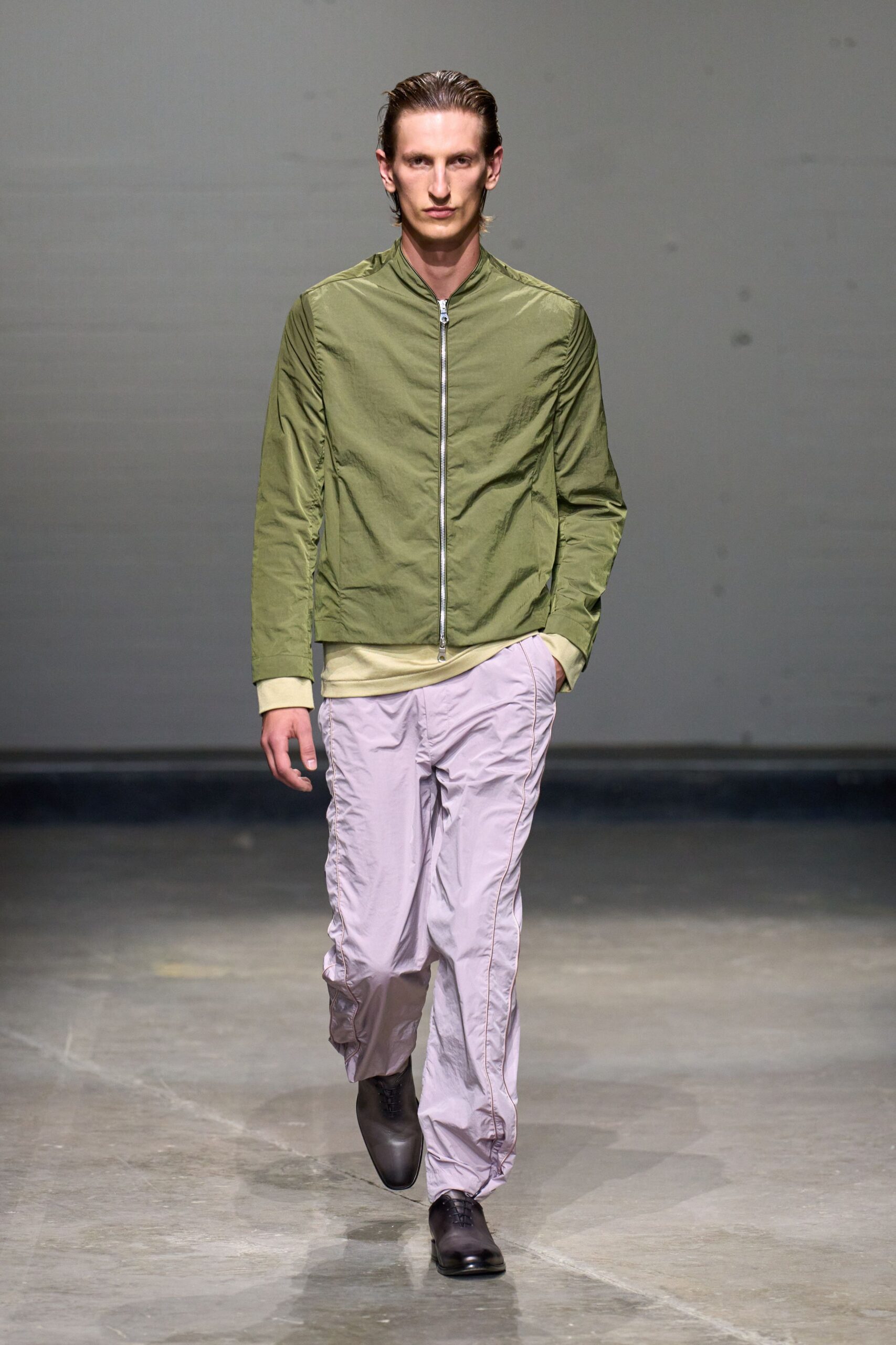 green fitted jacket with purple pants