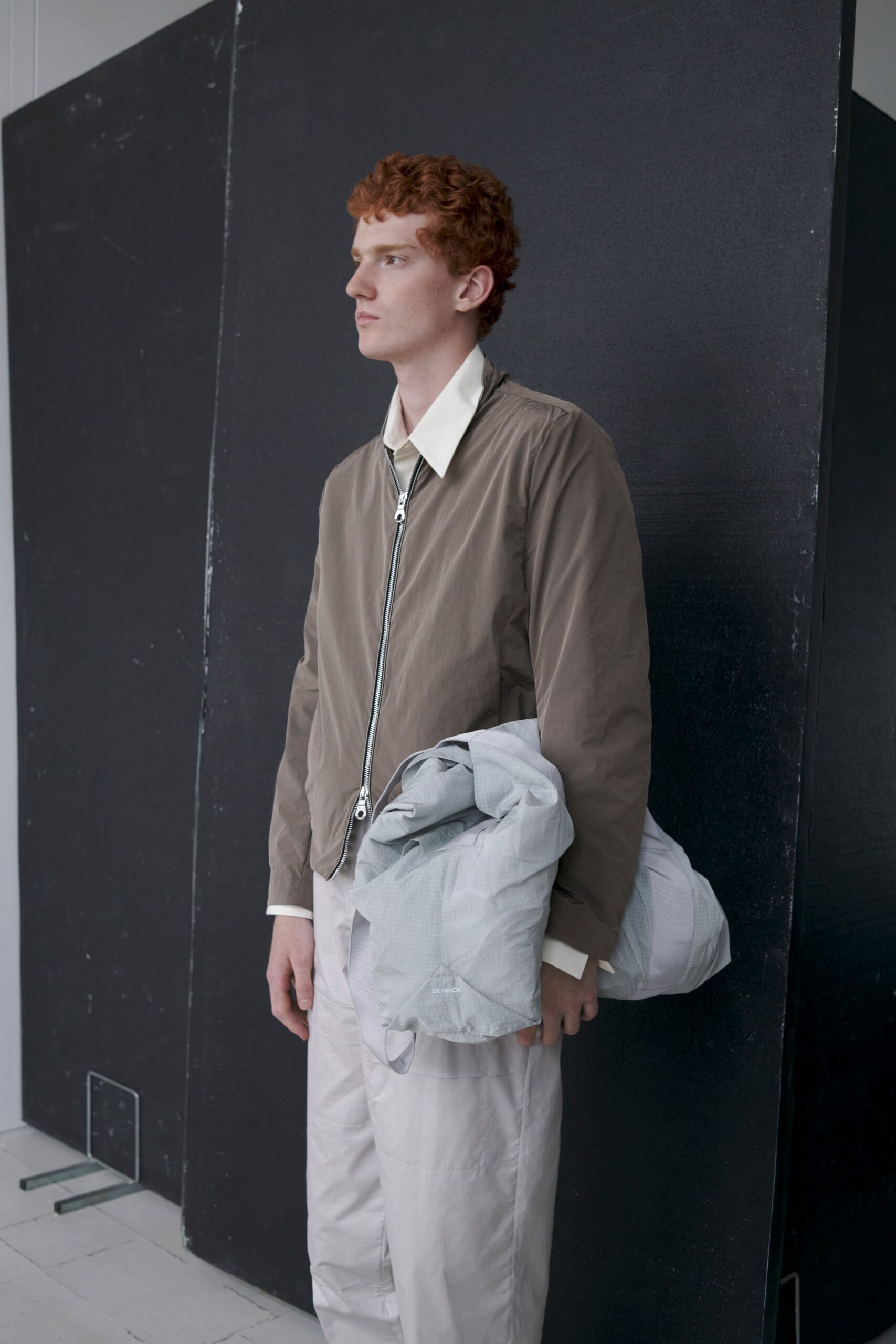 brown jacket white shirt beige pants