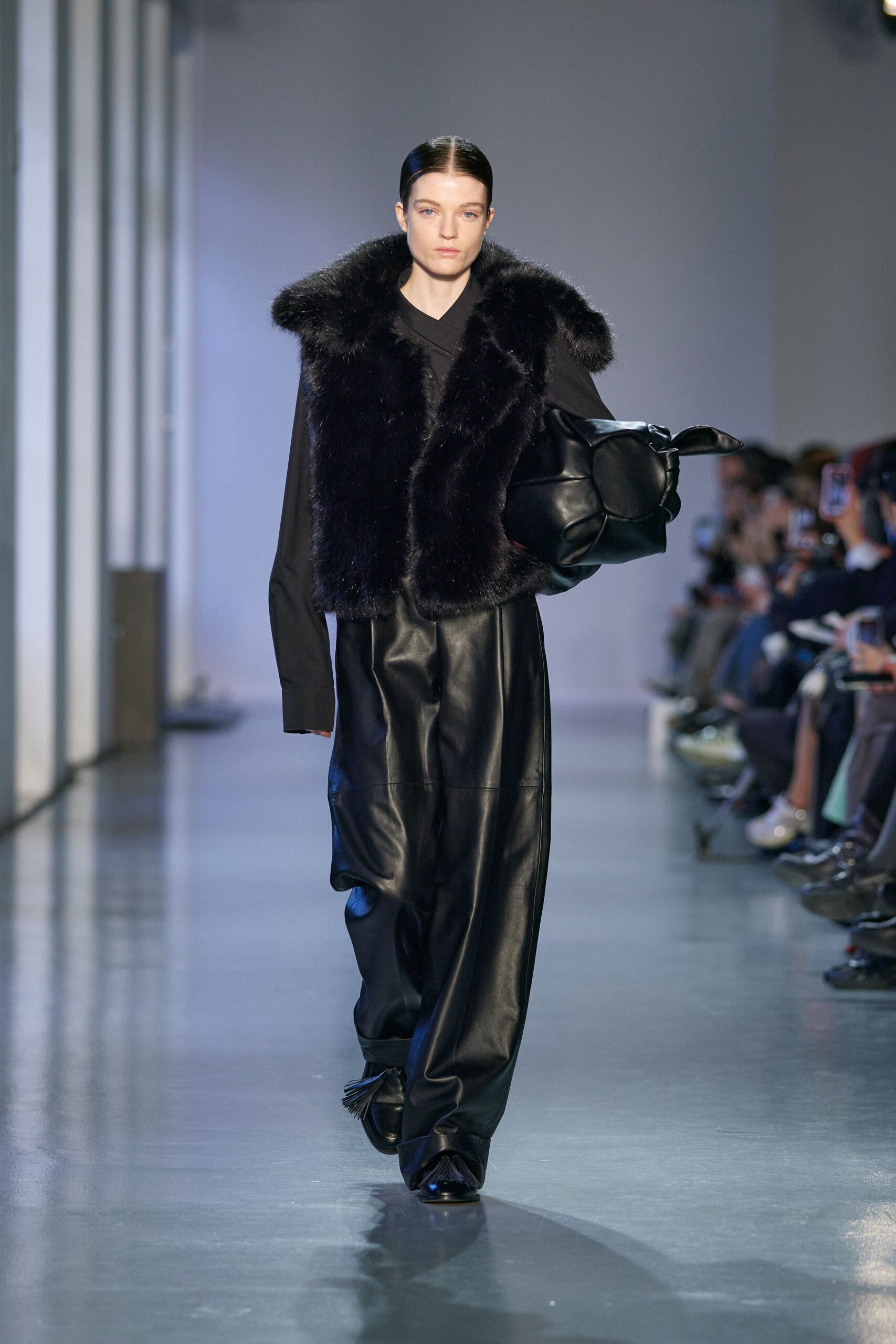 black faux-fur vest and leather pants