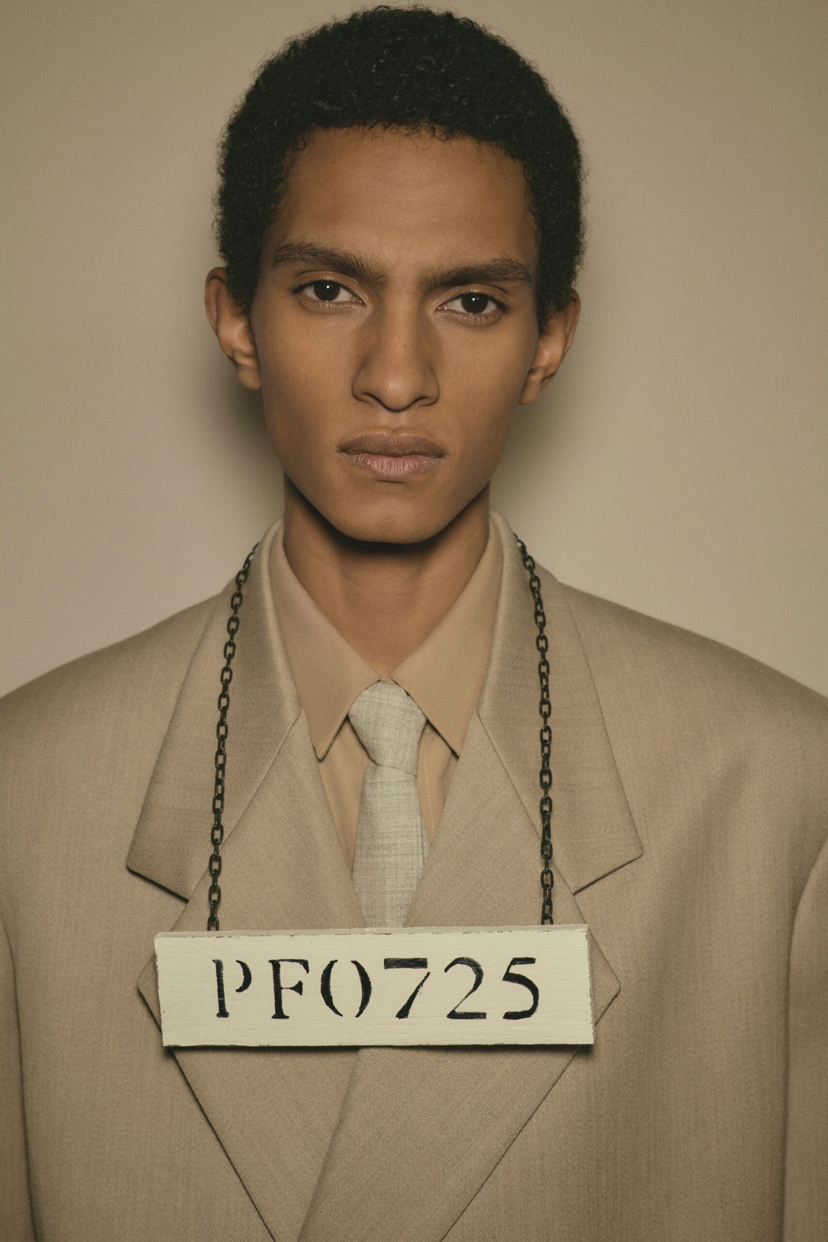 beige tailored suit with gray tie