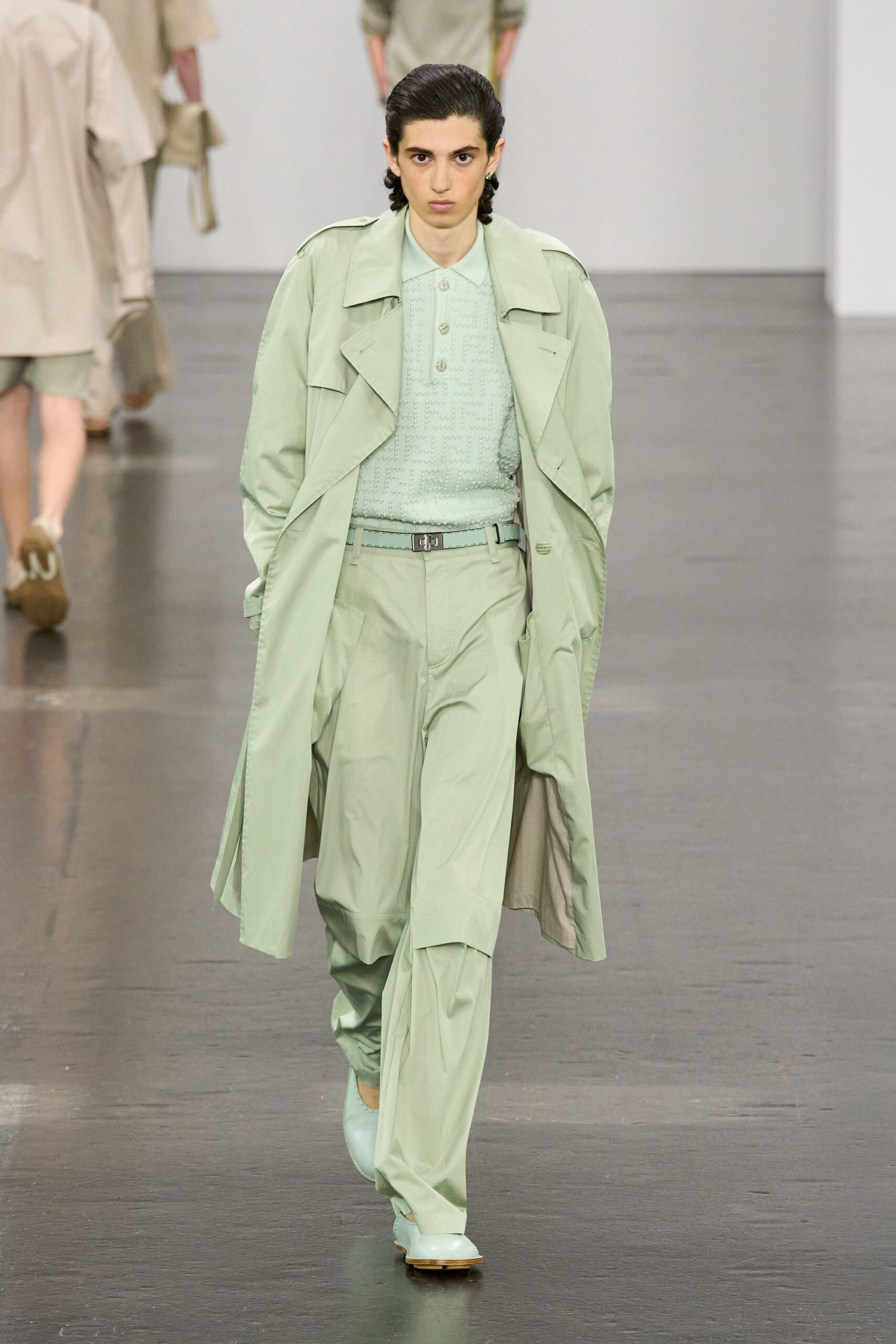 green trench coat with shirt and pants