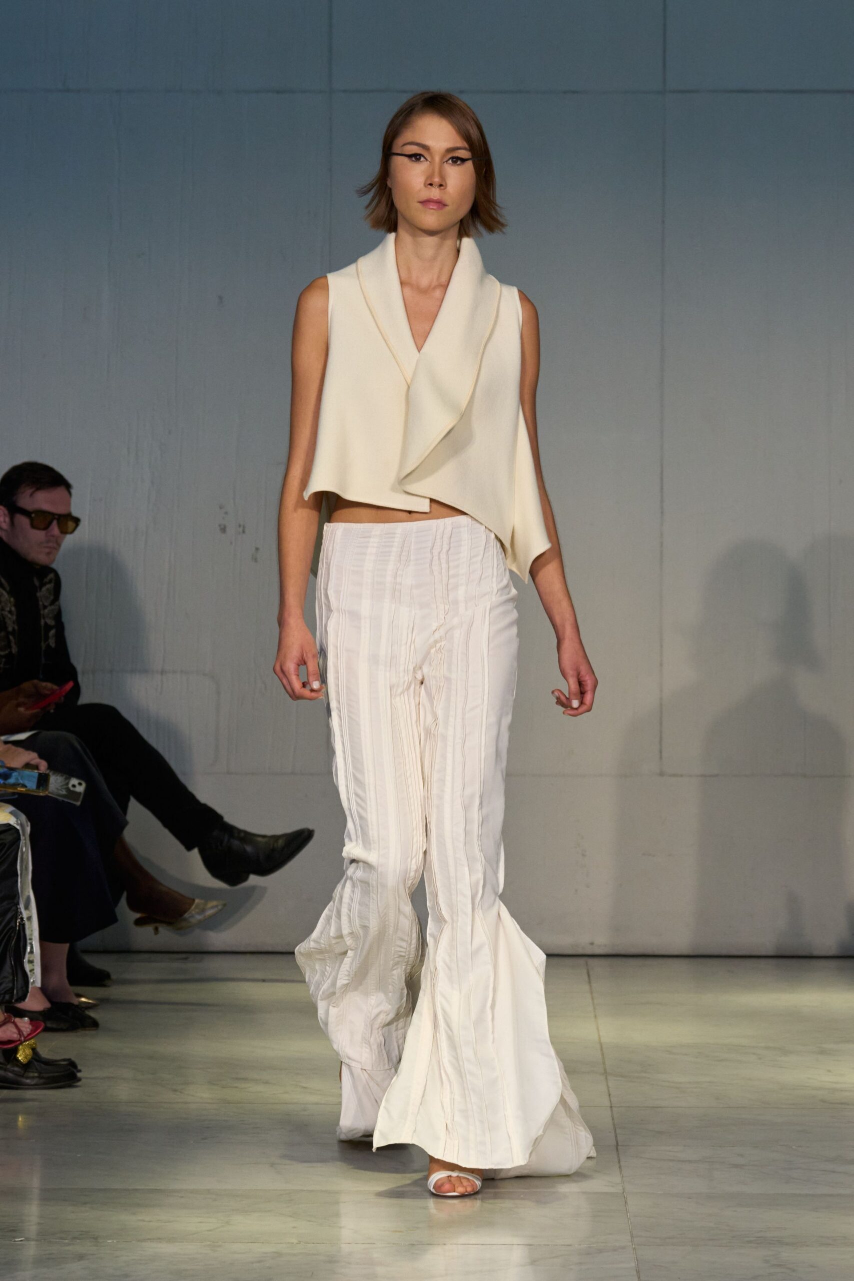 white draped top with flared pants