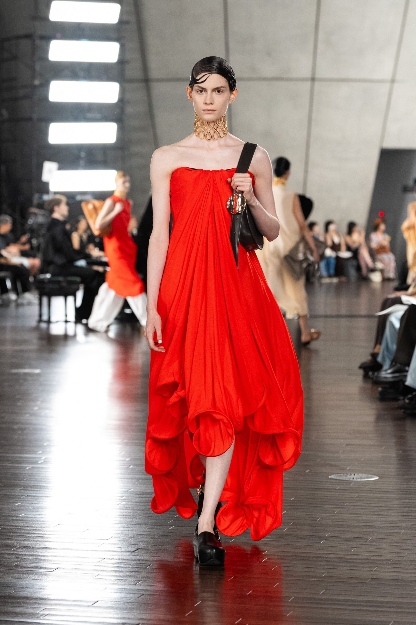red silk strapless fitted draped tiered flowing gown