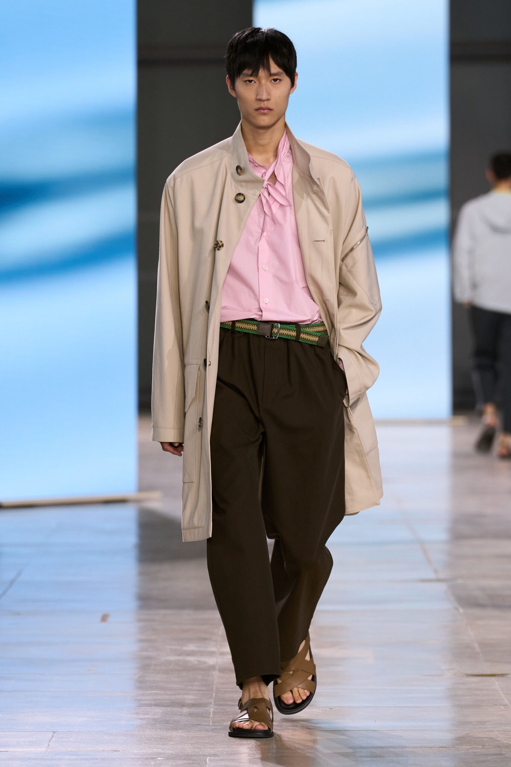 beige coat pink shirt brown pants