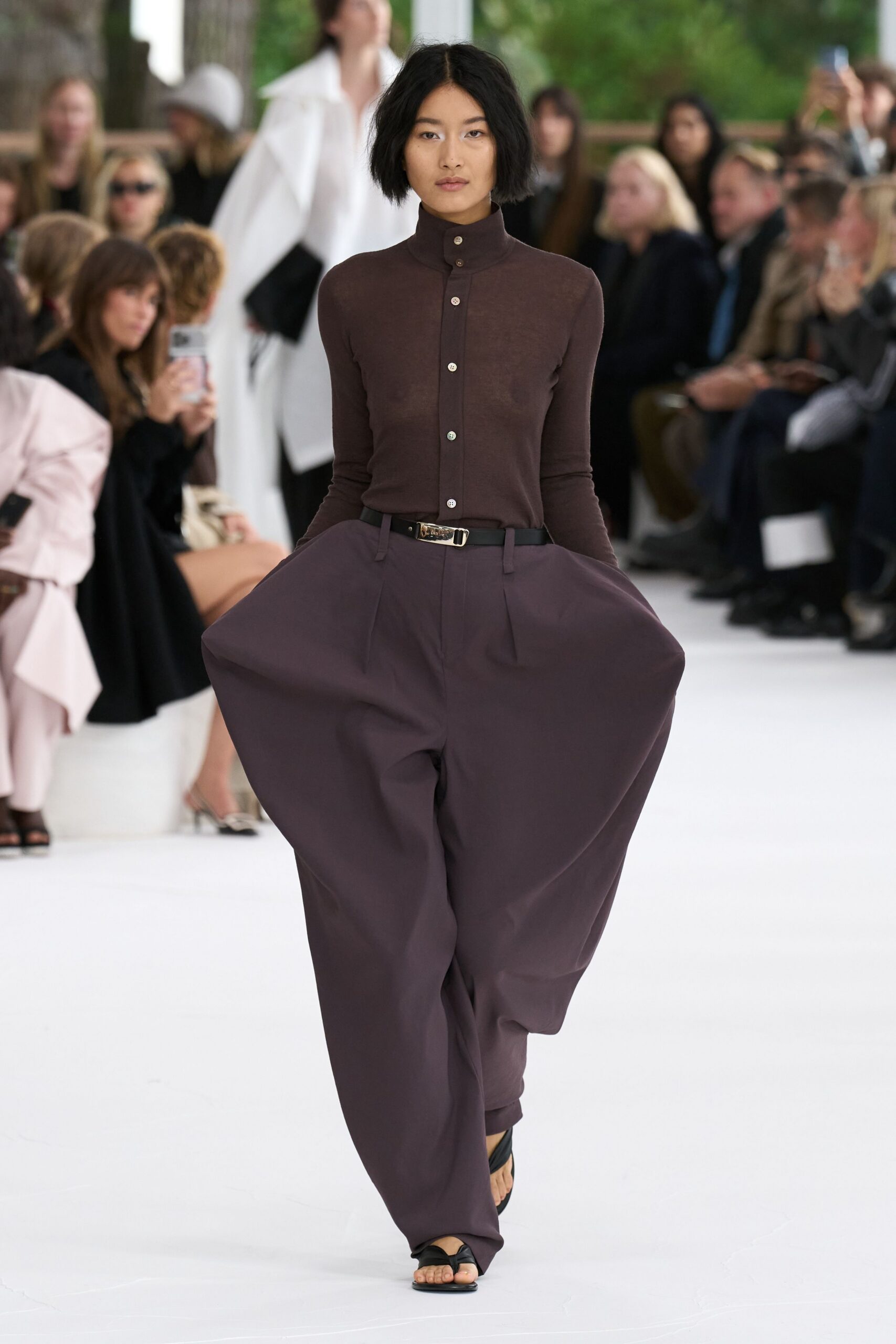 brown fitted top with purple pants