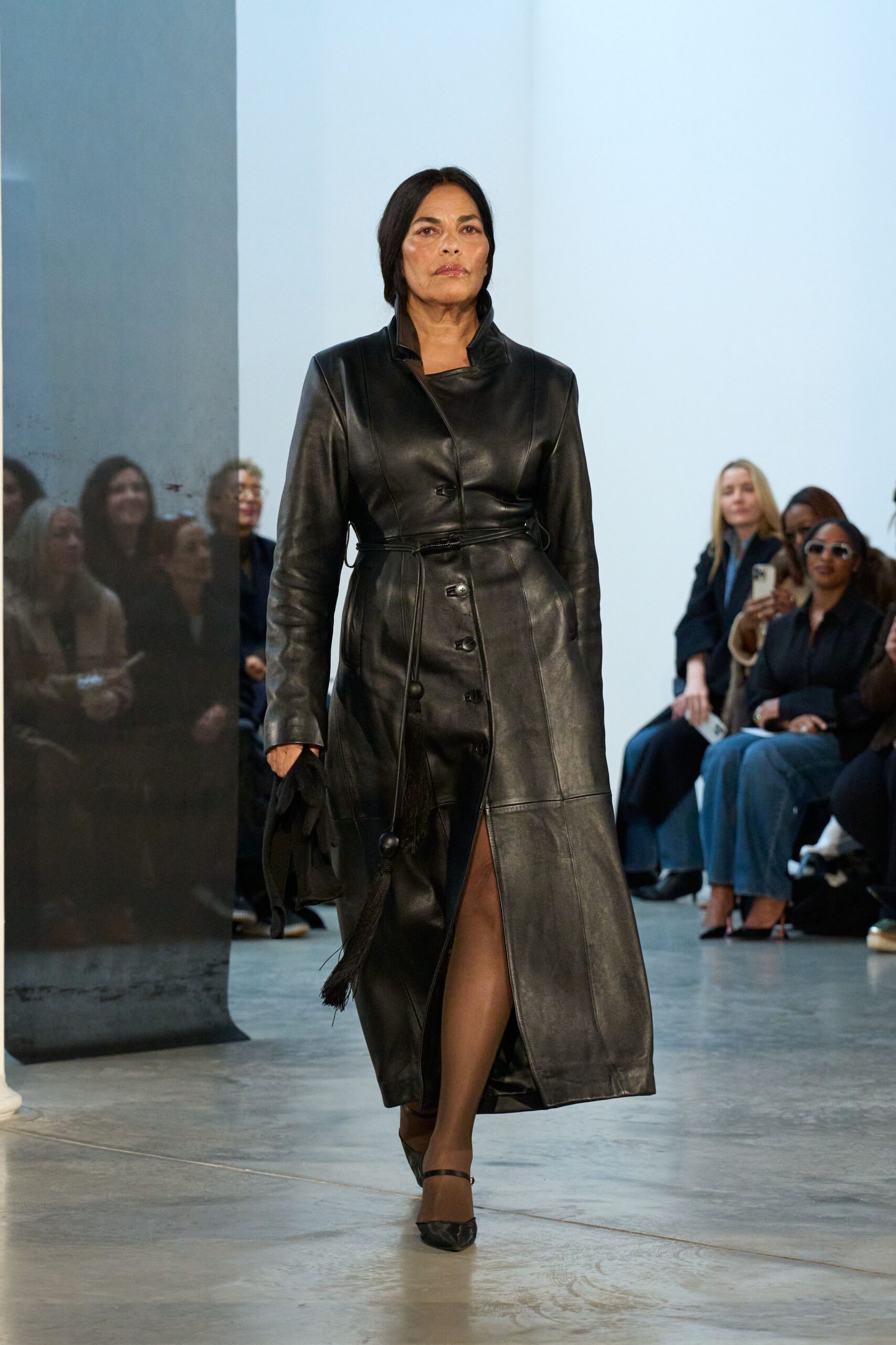 black leather long-sleeve collared fitted buttoned belted coat