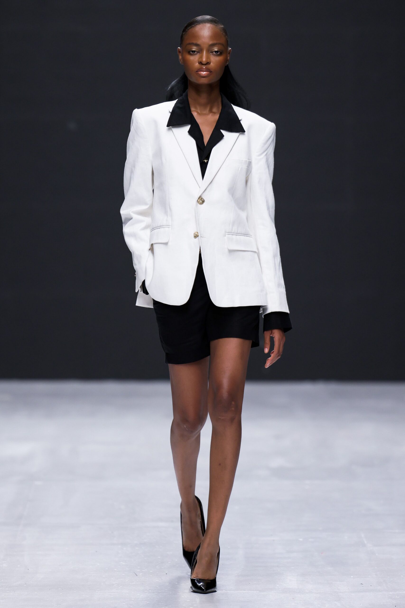 white blazer black shirt shorts
