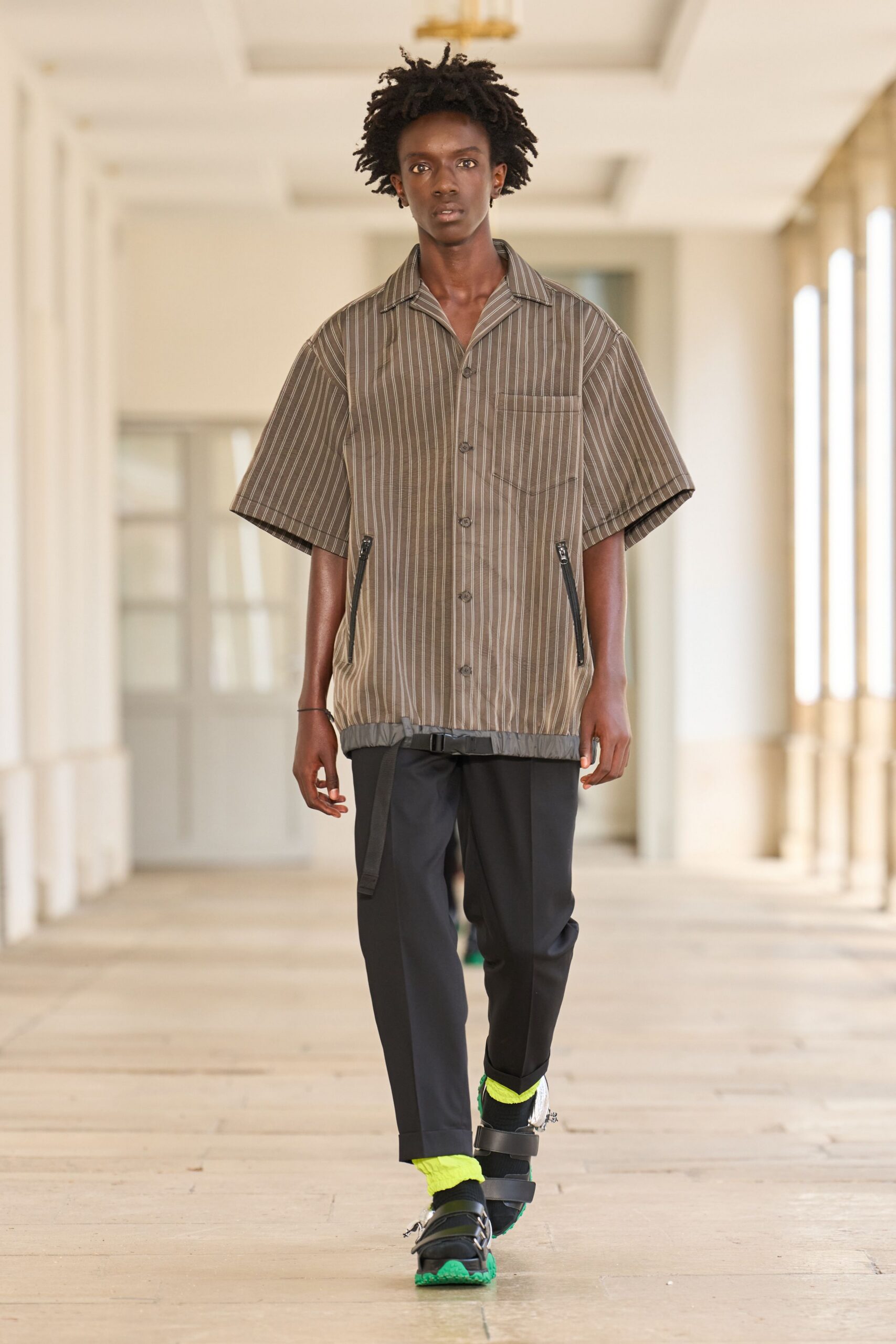 brown striped short-sleeve shirt with black pants