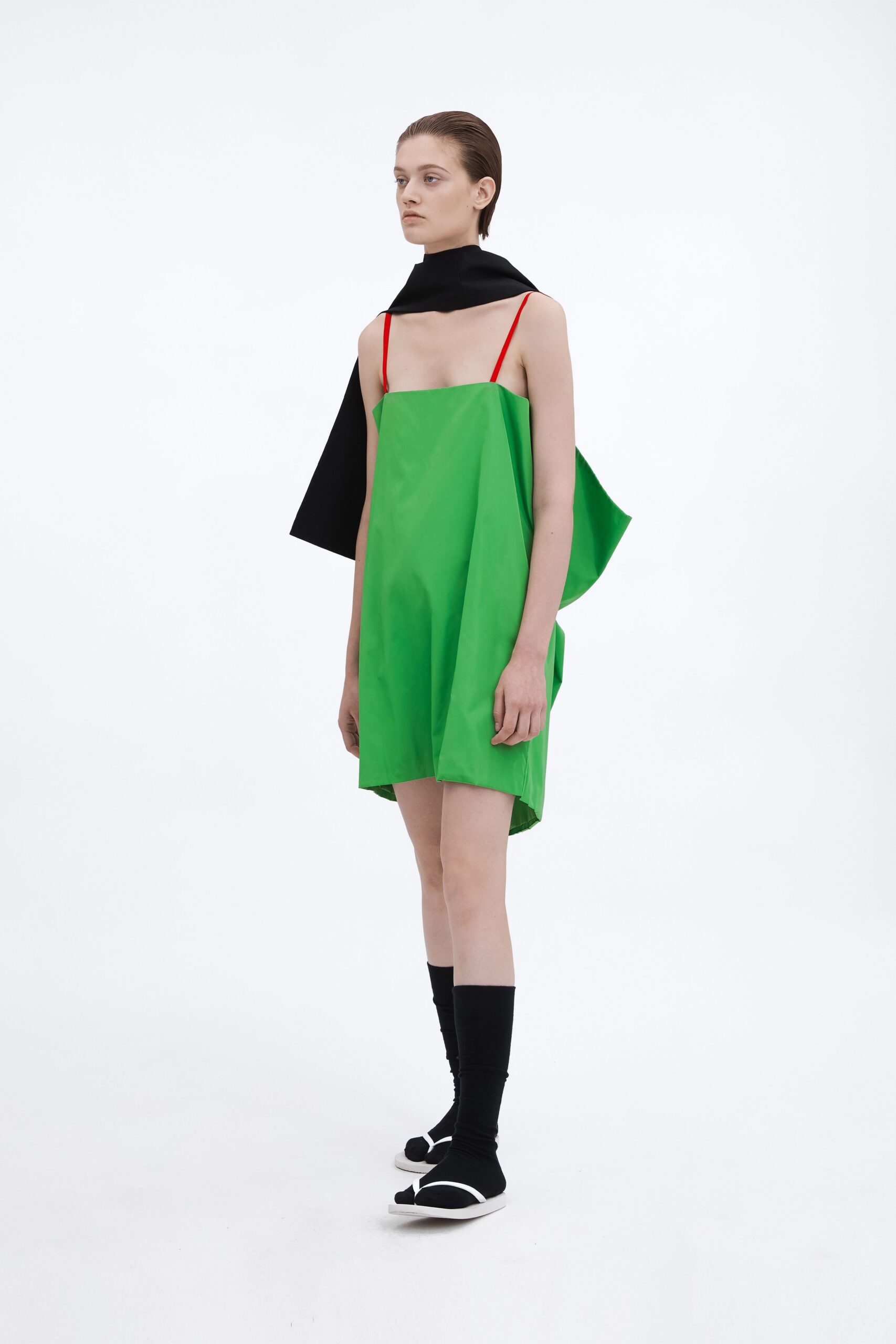 green mini dress with black cape