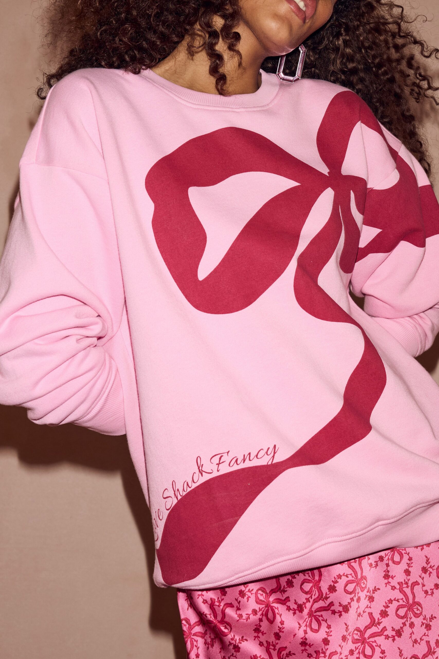 pink cotton long-sleeve collared relaxed printed sweater