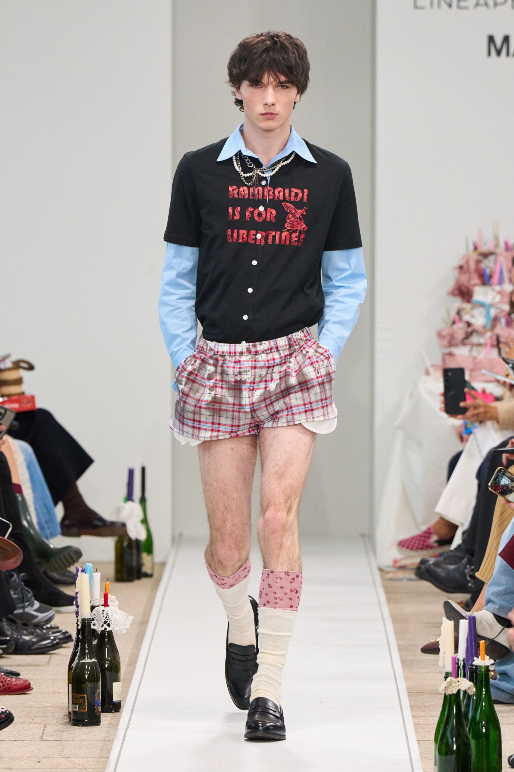 black and blue shirt with plaid shorts