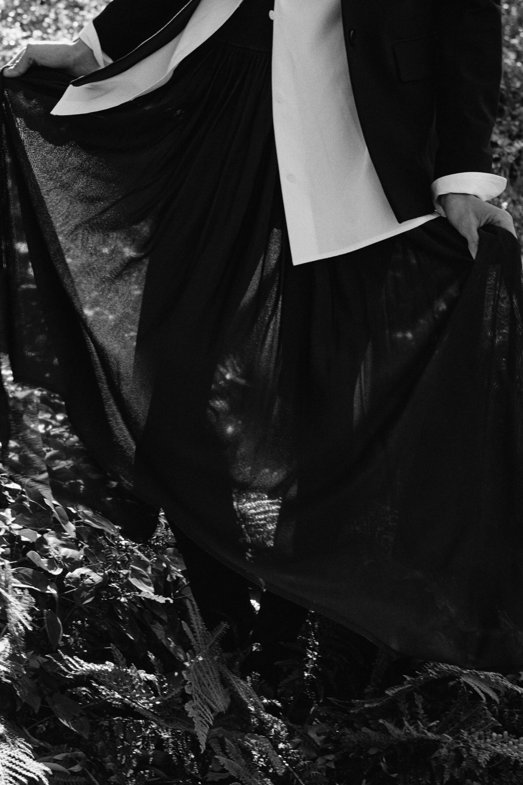 black silk fitted high-waisted pleated flowing midi skirt