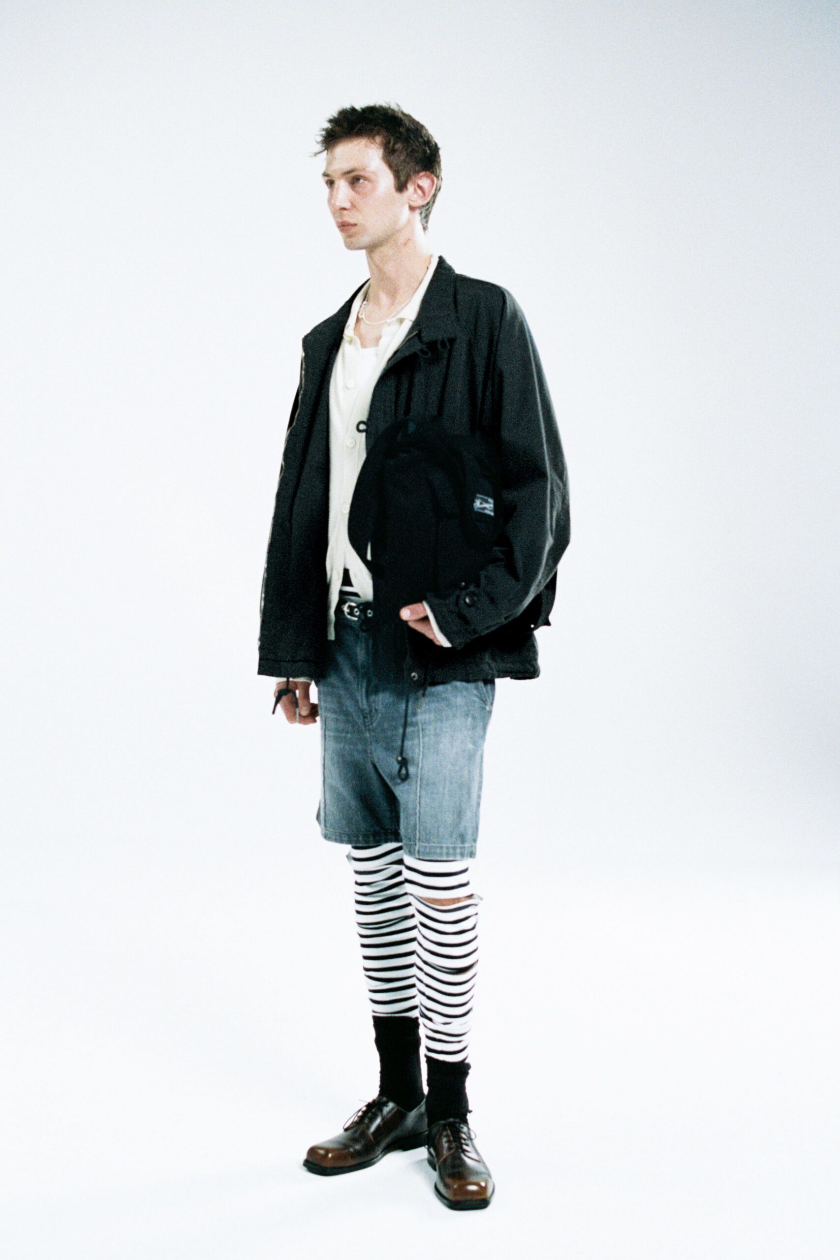 black jacket white shirt denim shorts