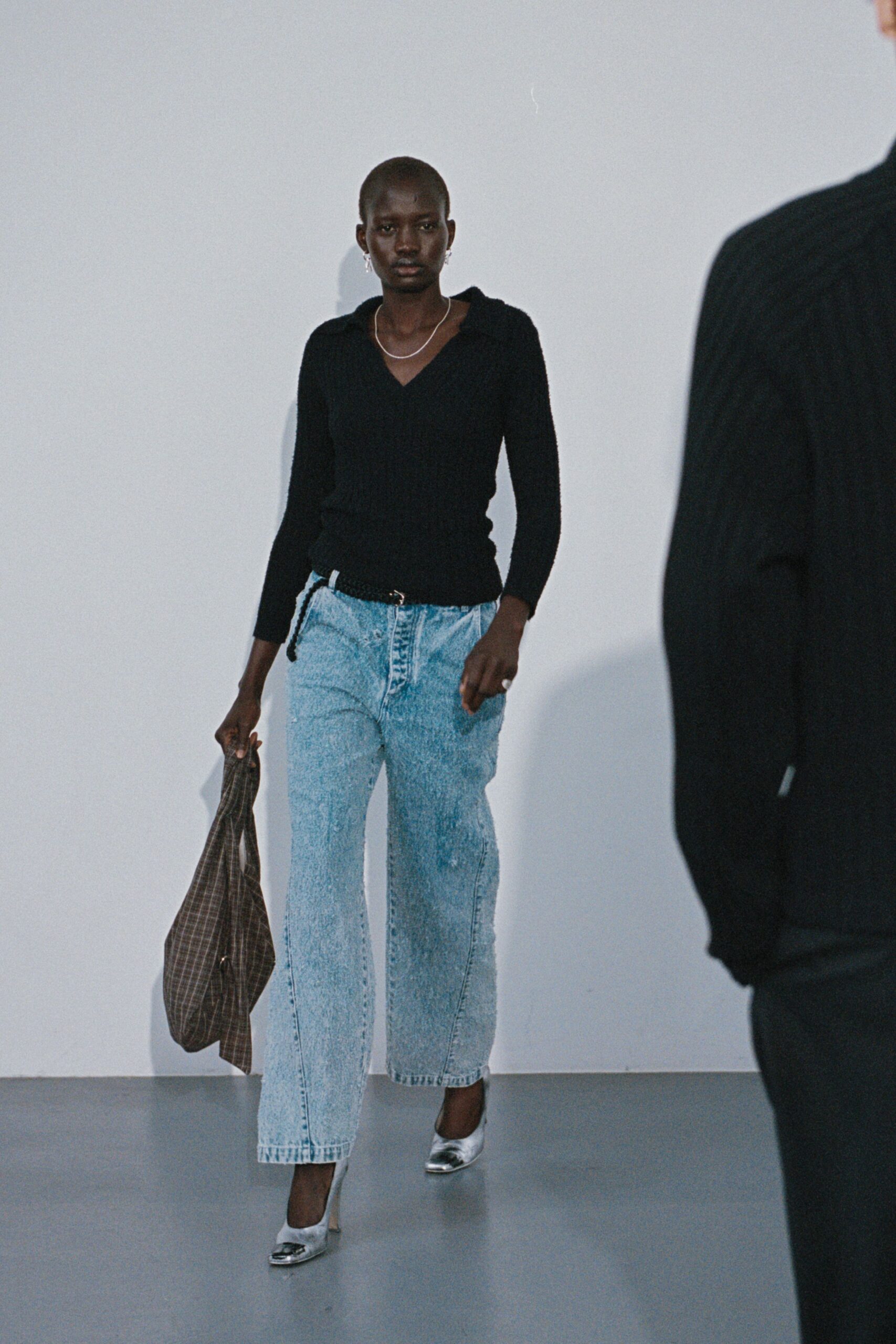 black fitted knit top with wide-leg jeans
