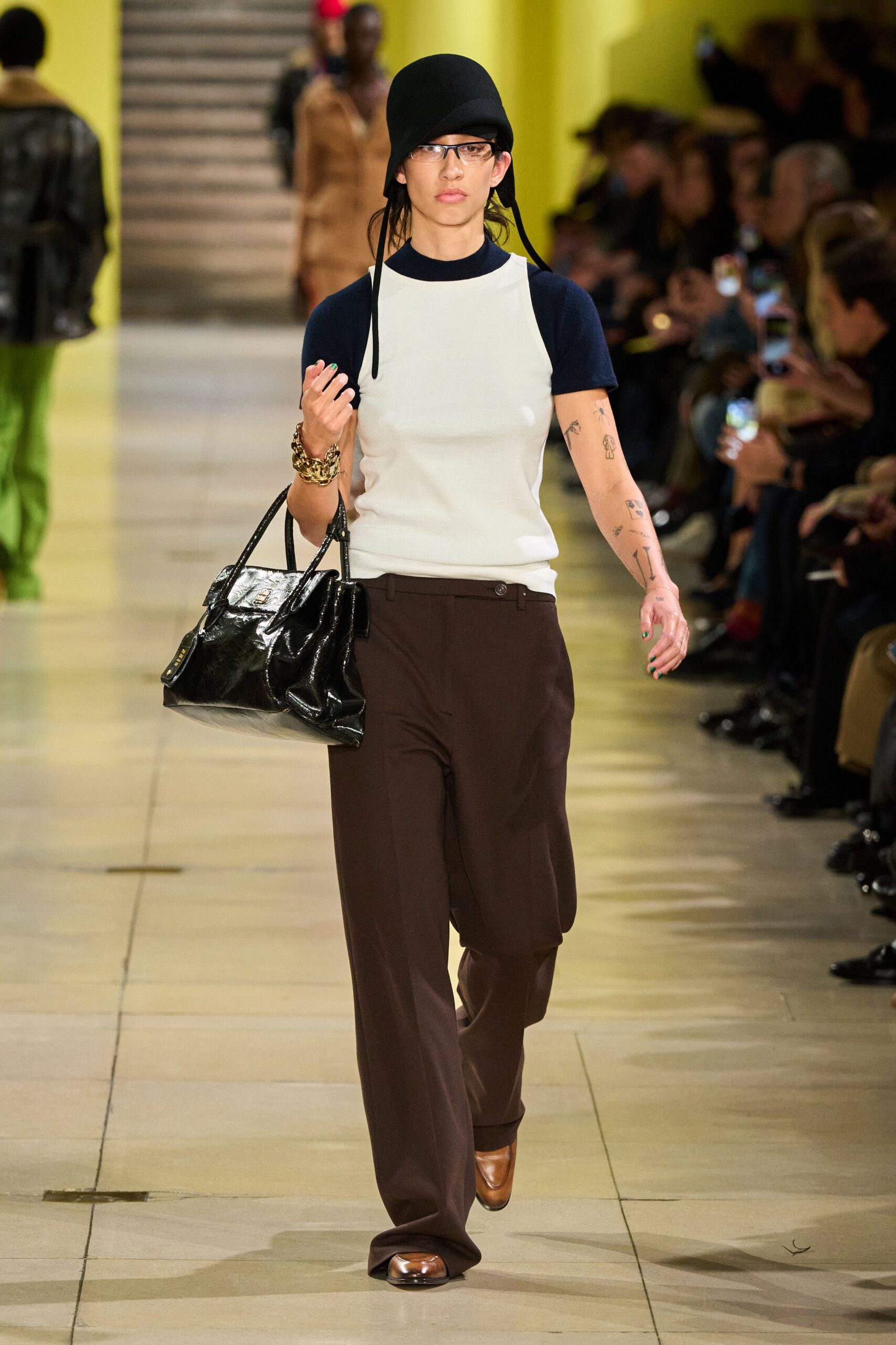 white and blue fitted top with brown pants