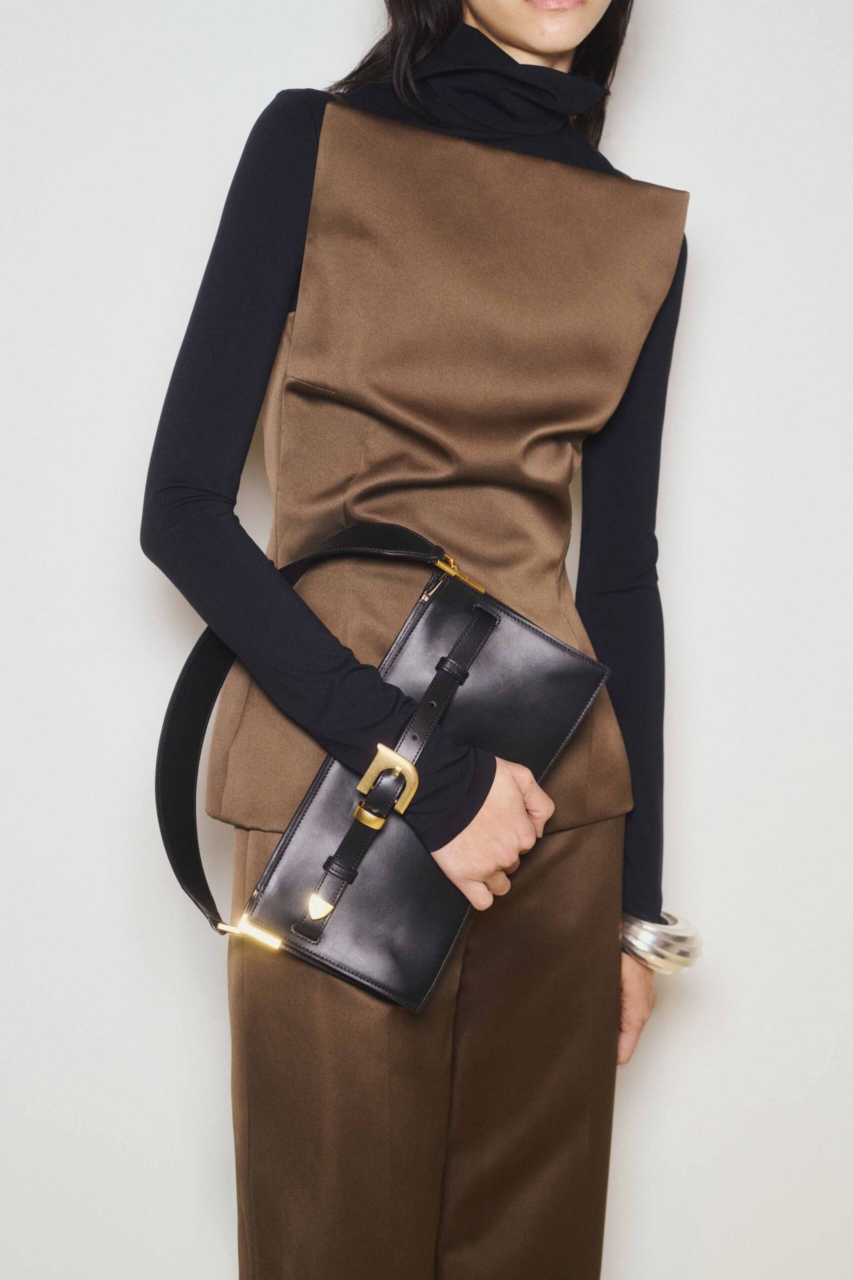 brown fitted top with black bag