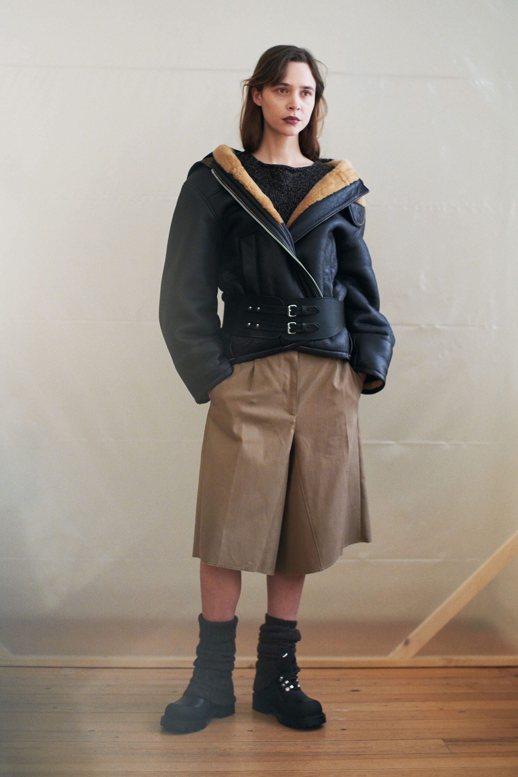 black leather long-sleeve hooded fitted zippered belted jacket
