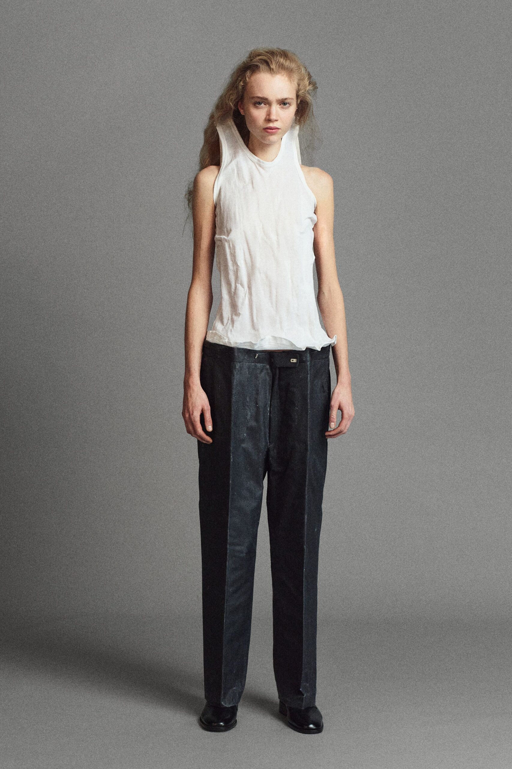 white sleeveless top with black pants