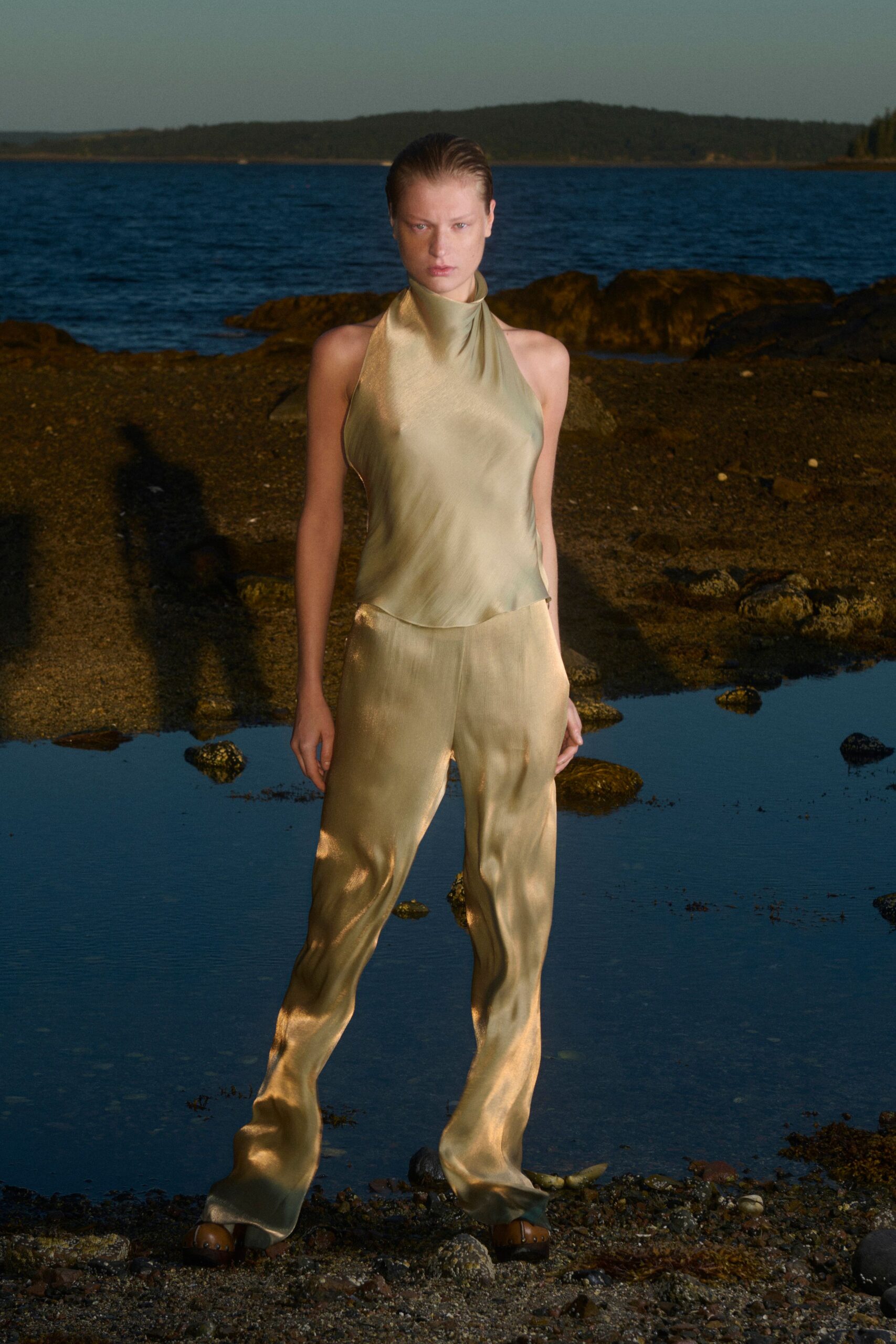 green silk sleeveless high-neck fitted draped flowing top