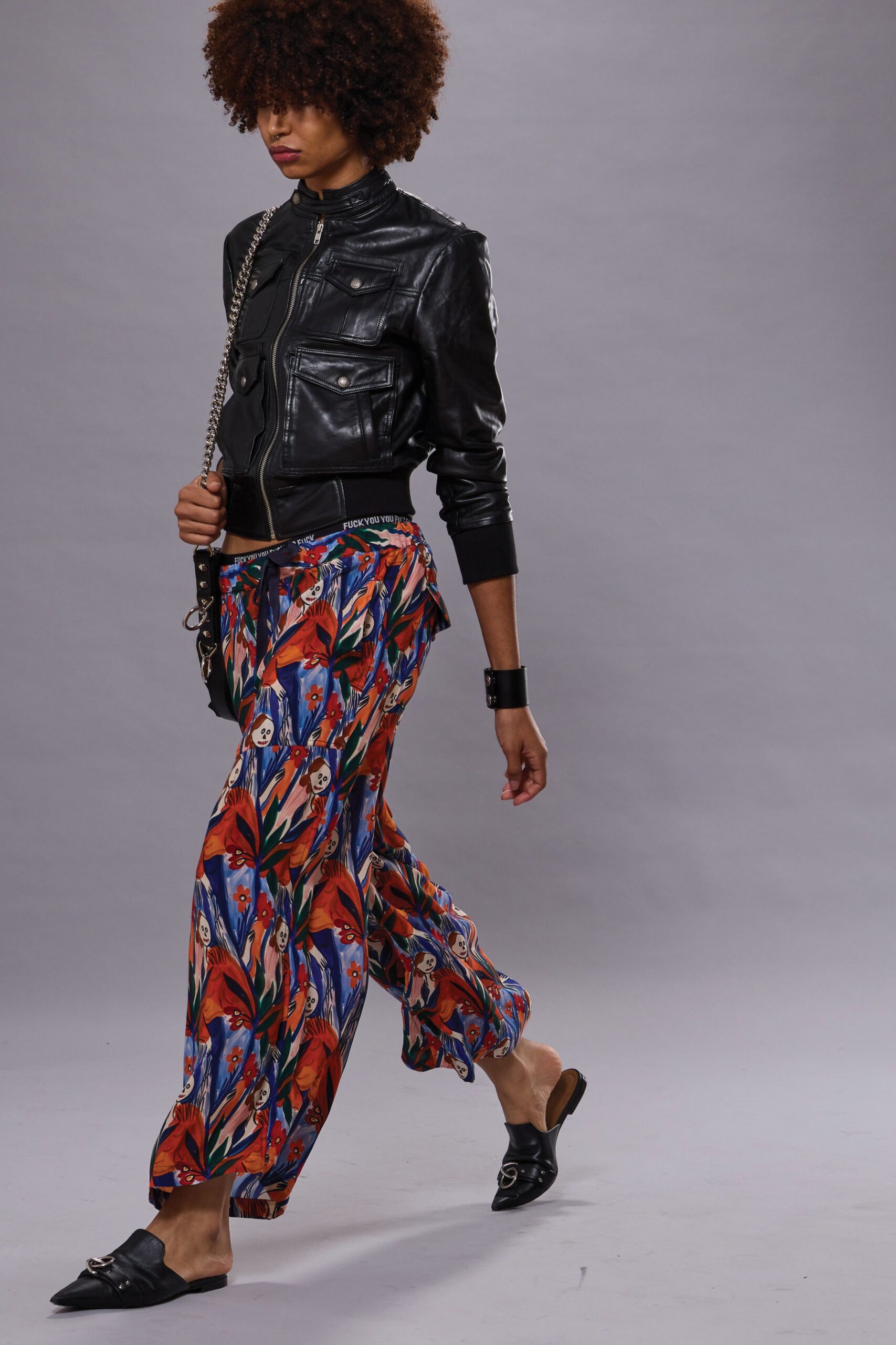 black leather jacket with colorful pants