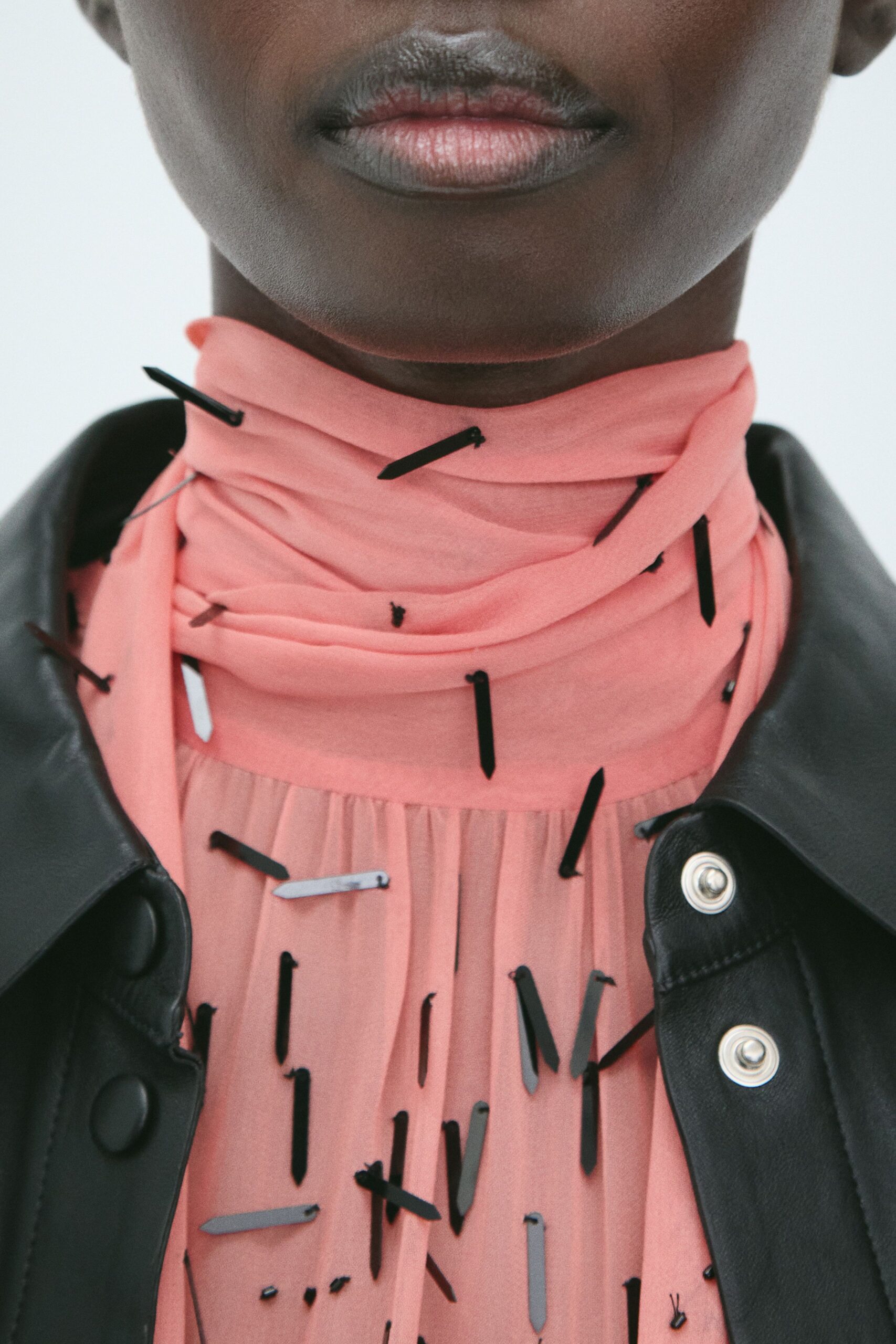 pink silk fitted top with black leather jacket