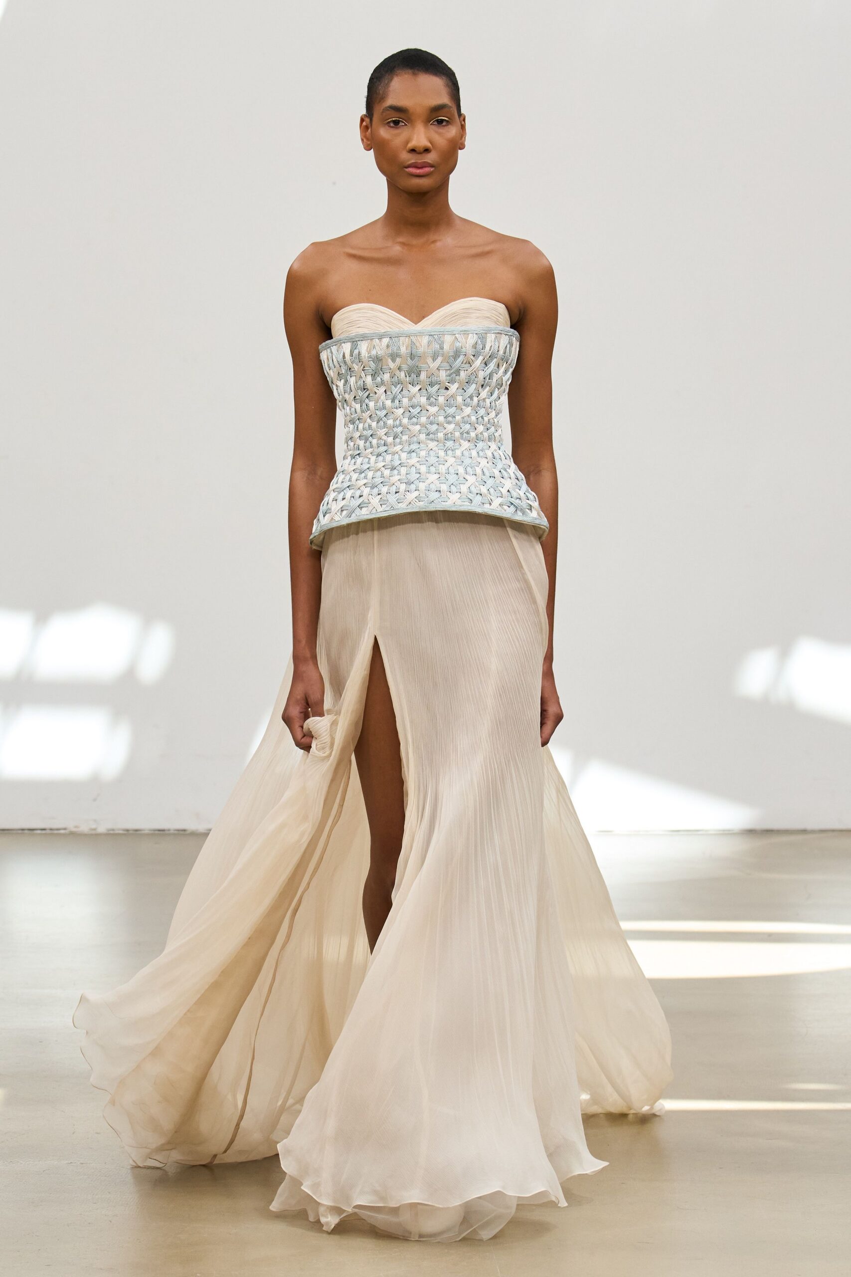 beige silk strapless slit fitted pleated flowing gown