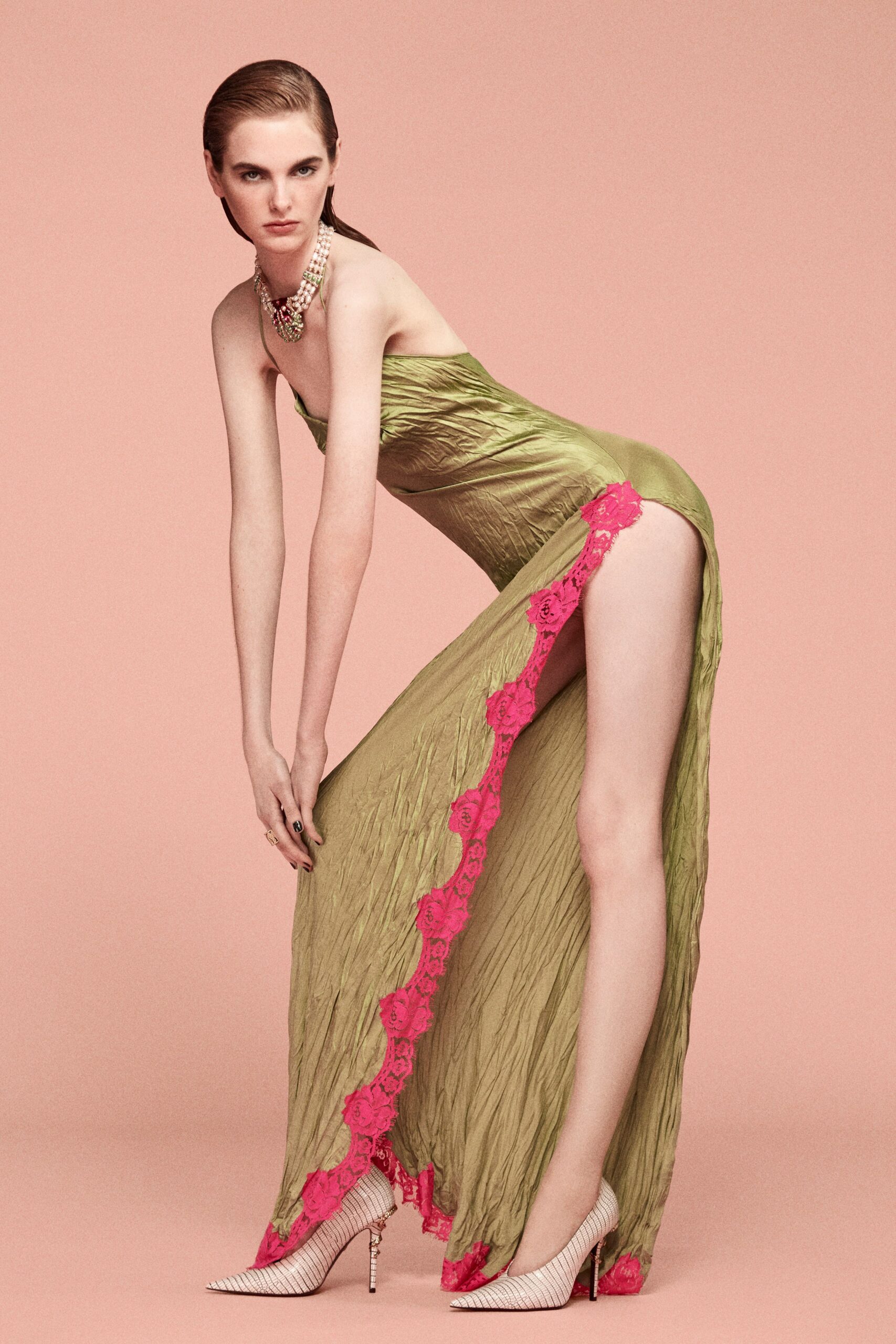green silk sleeveless low-cut fitted ruched layered gown