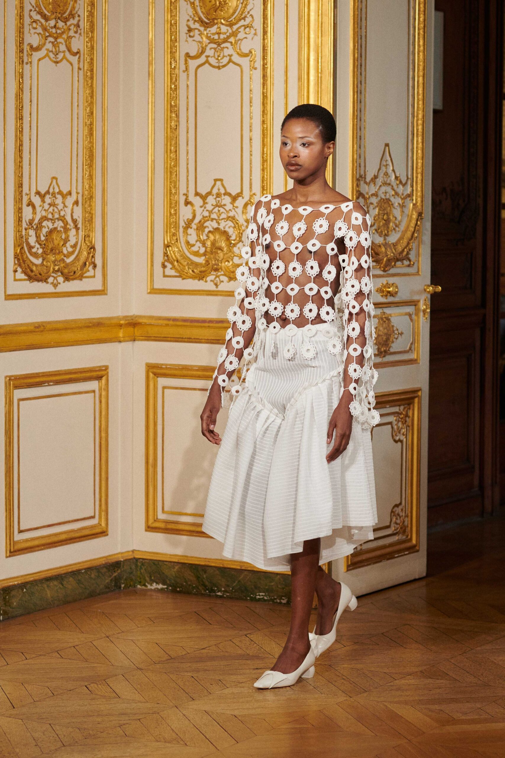white embroidered top and pleated skirt