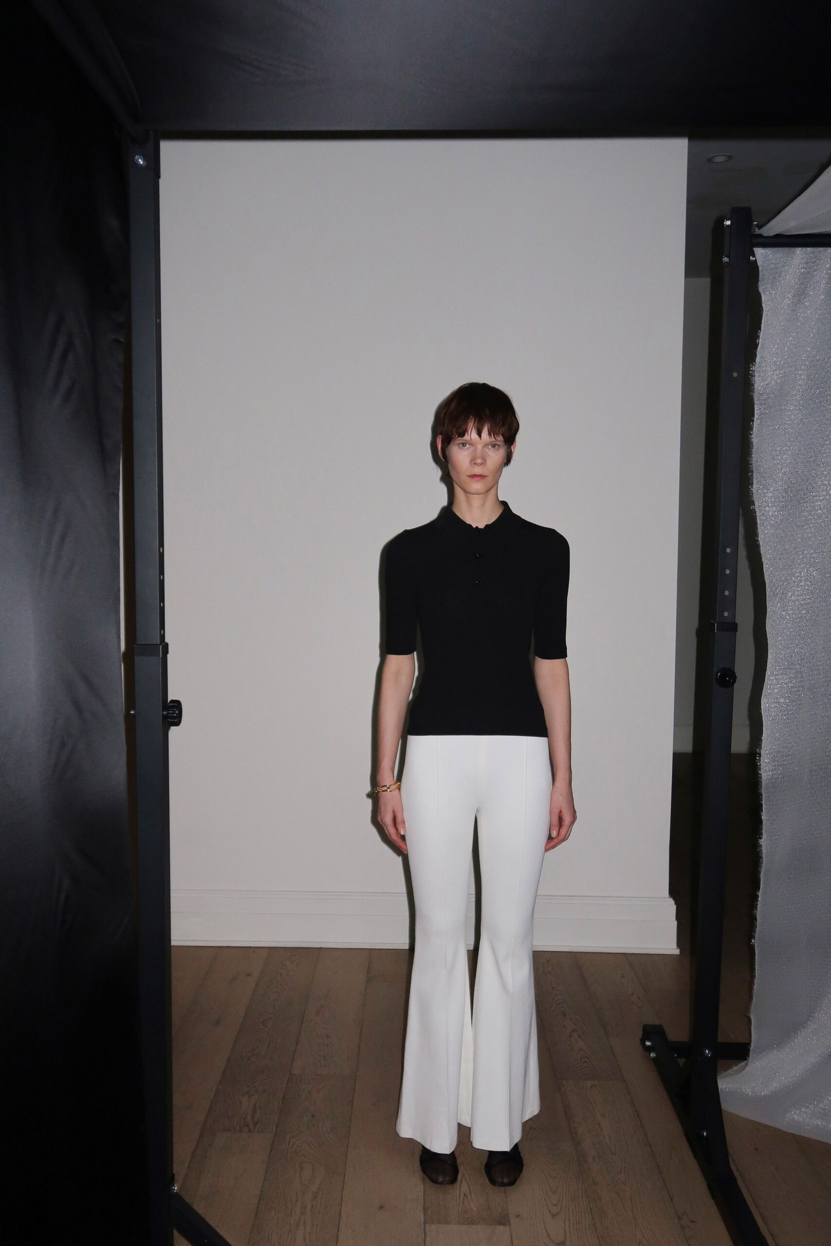 black fitted top white flared pants