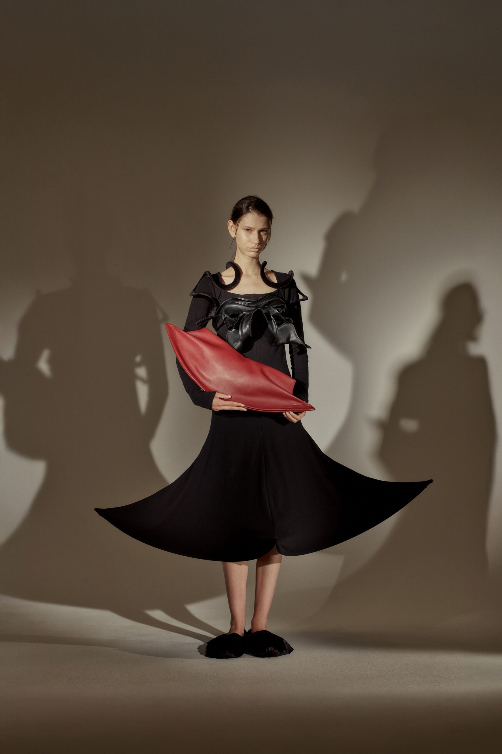 black midi dress with red bag