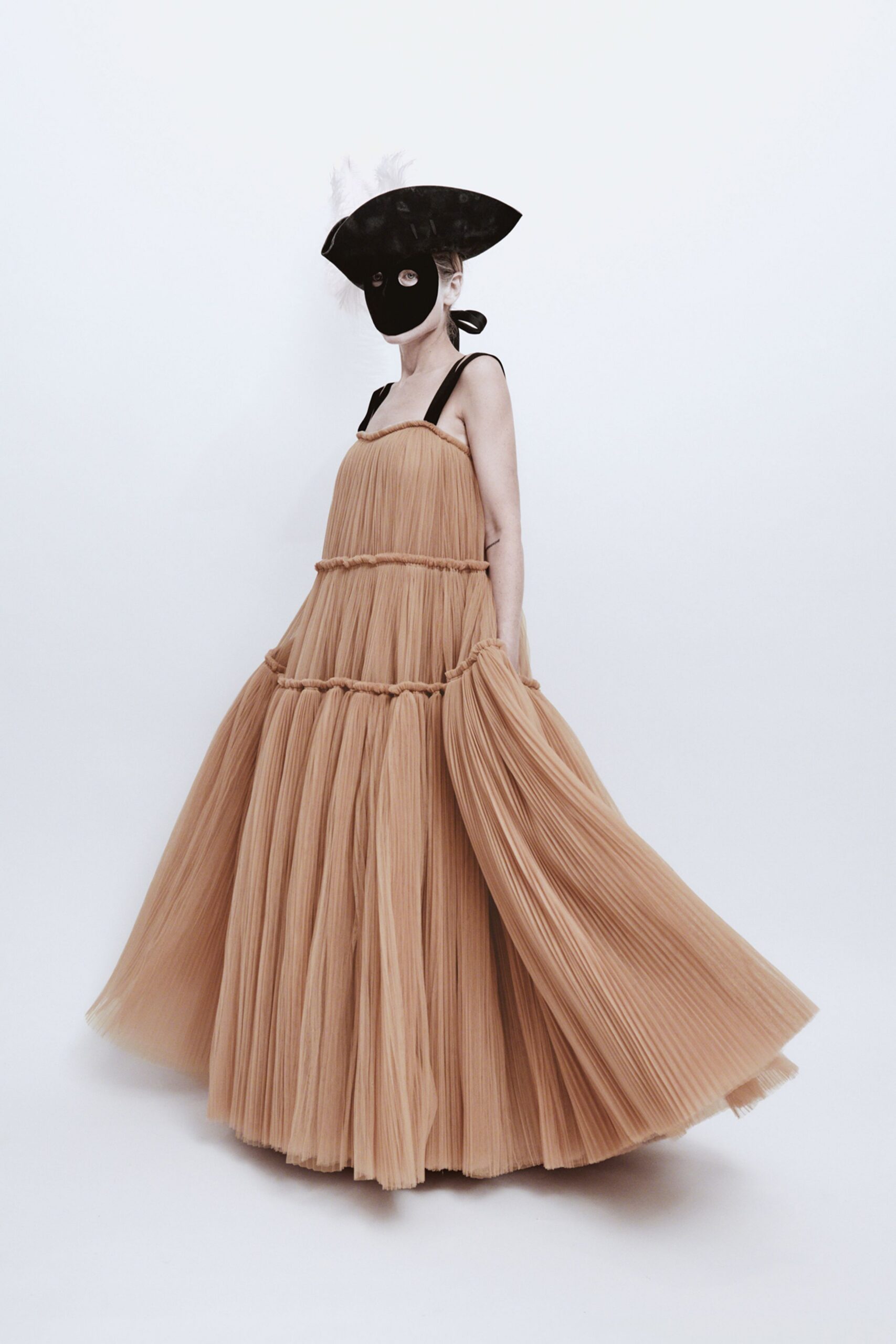 beige pleated tulle gown with black hat