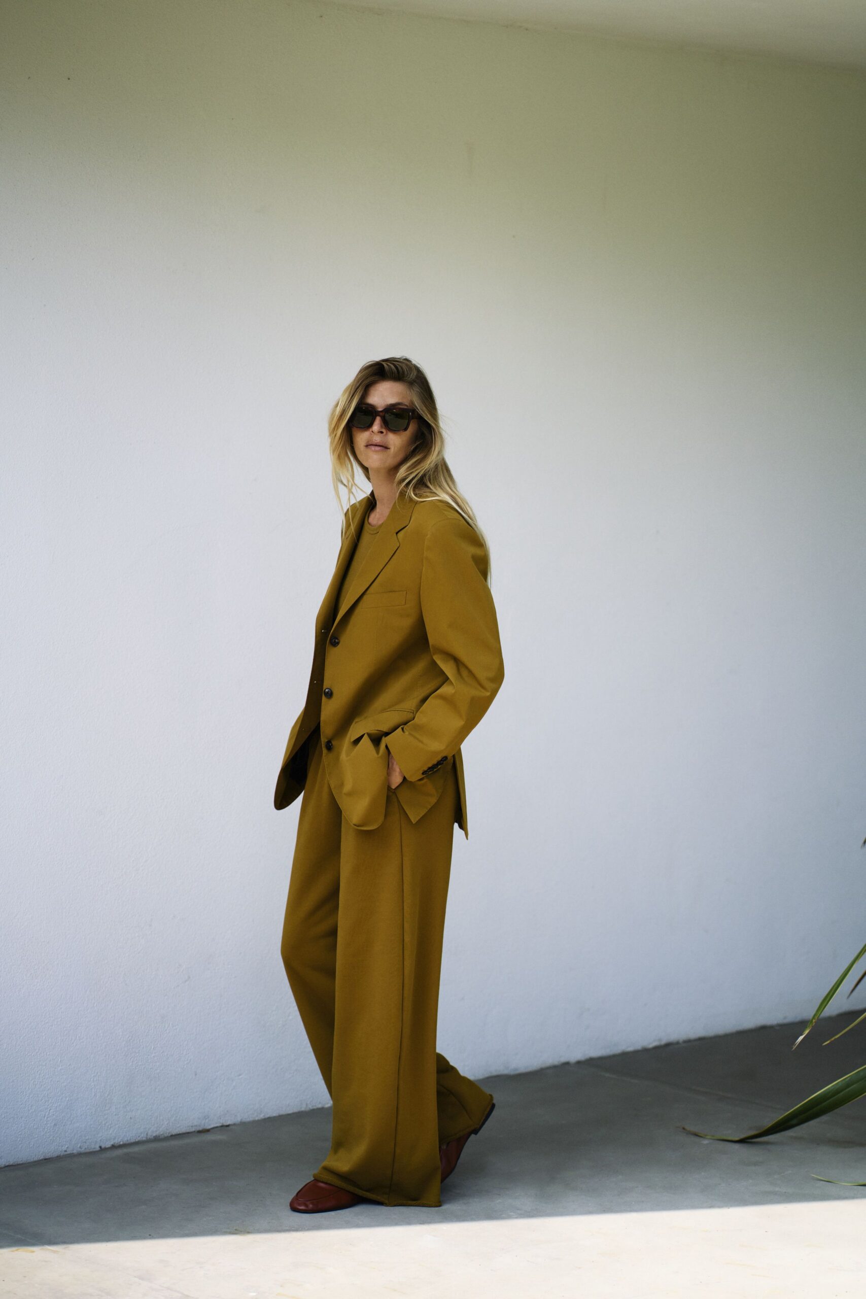 yellow tailored suit with sunglasses