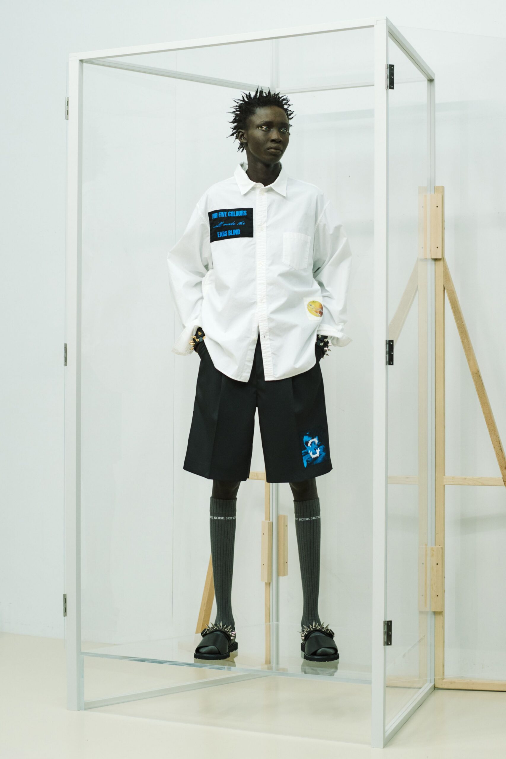 white relaxed shirt with black shorts