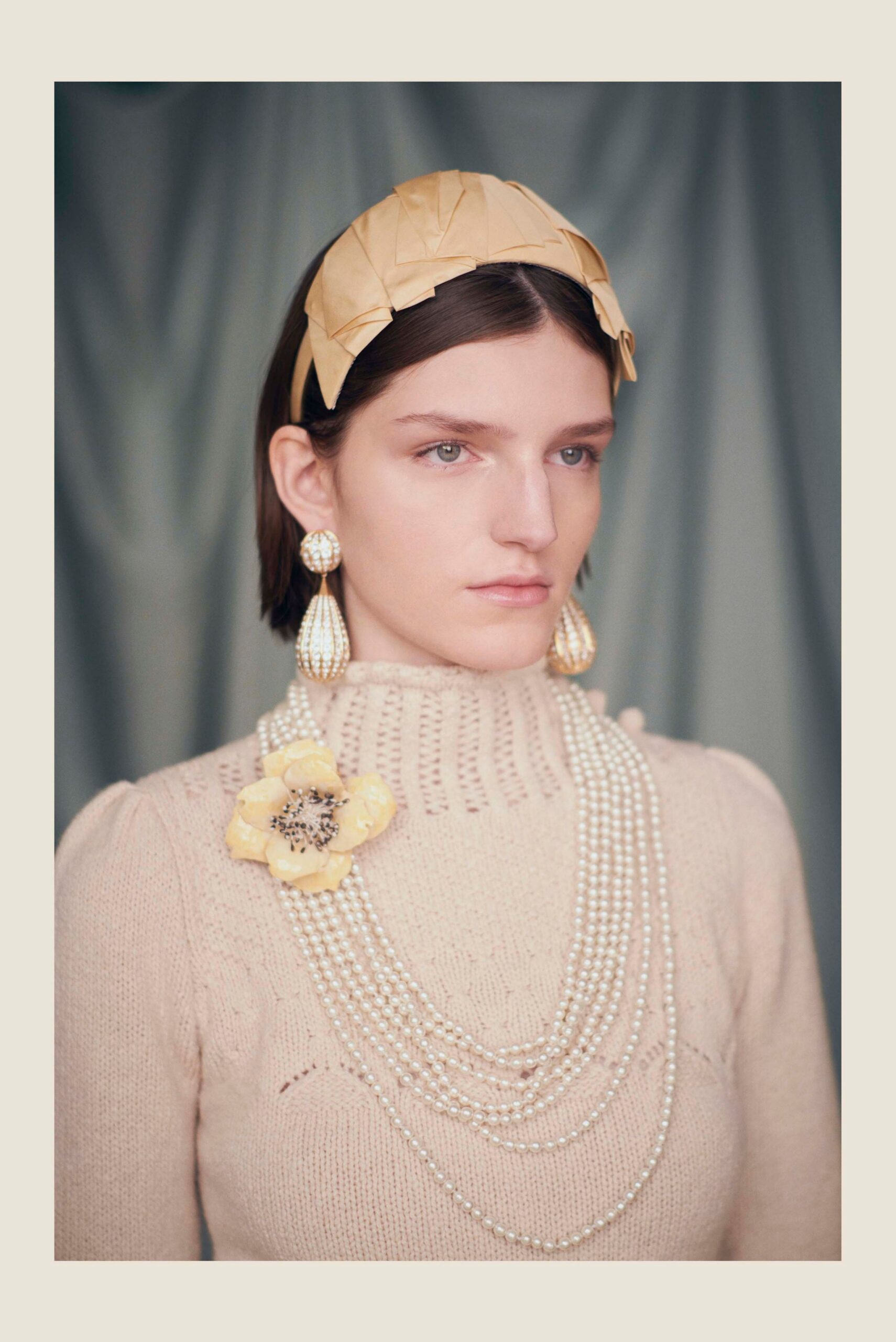 beige fitted sweater with accessories