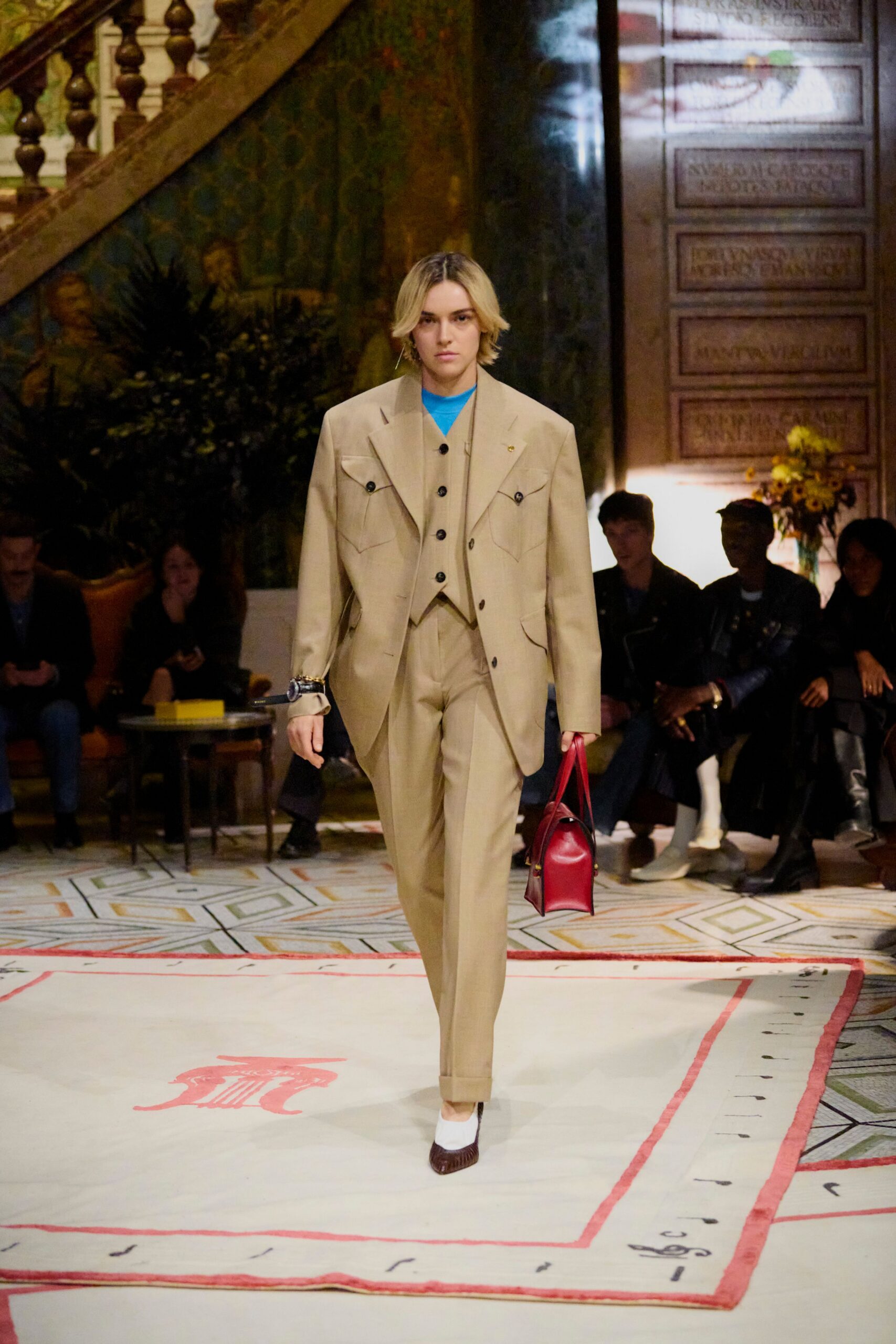 beige tailored suit with blue top