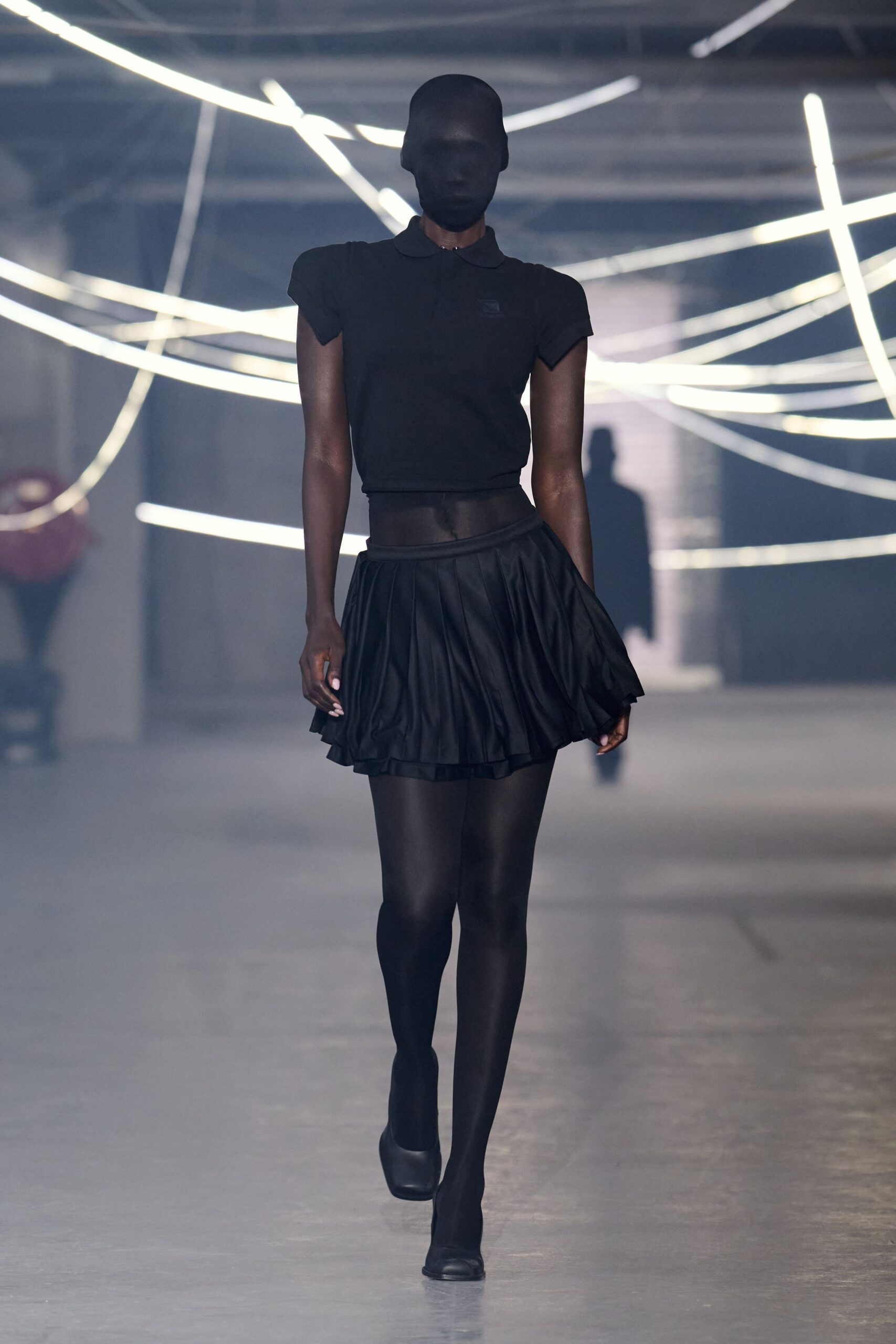black fitted top and mini skirt