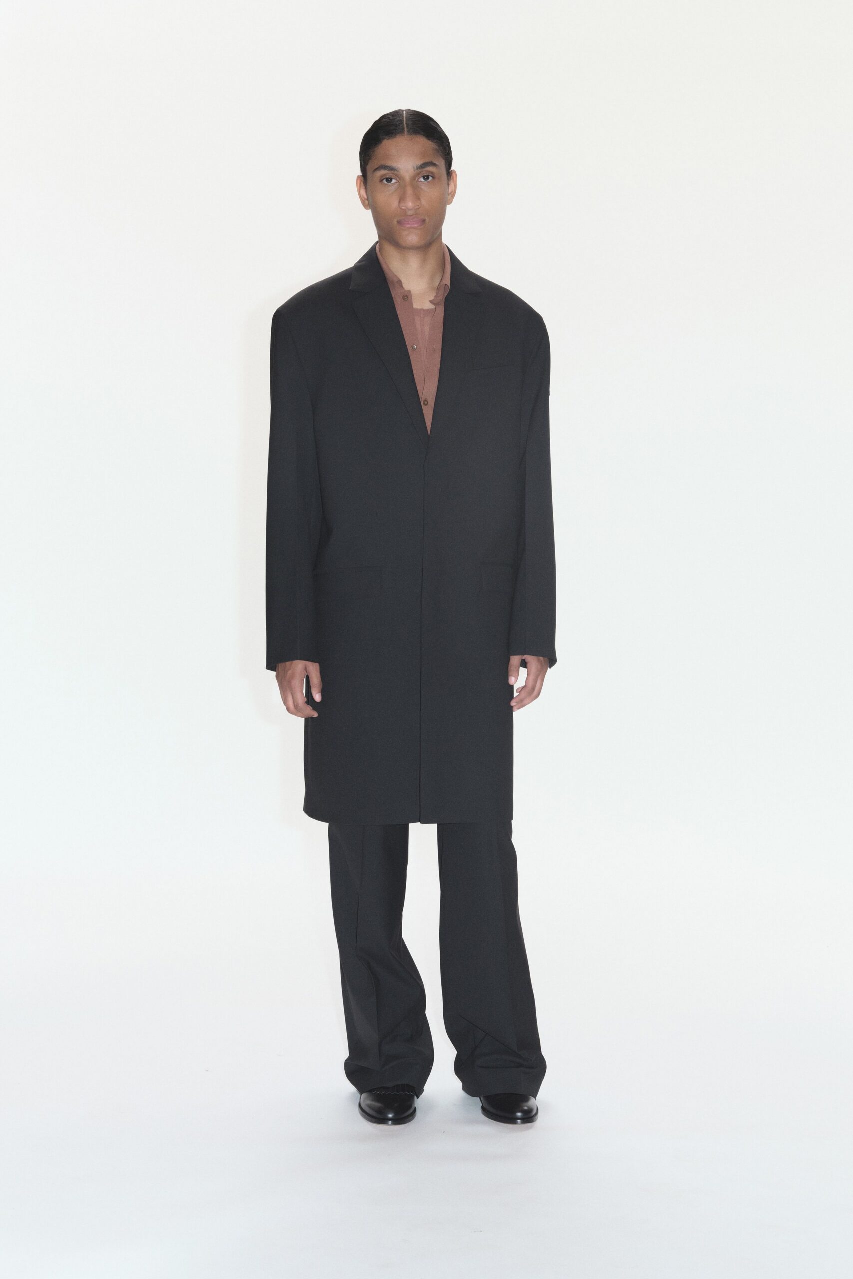 black coat brown shirt tailored pants