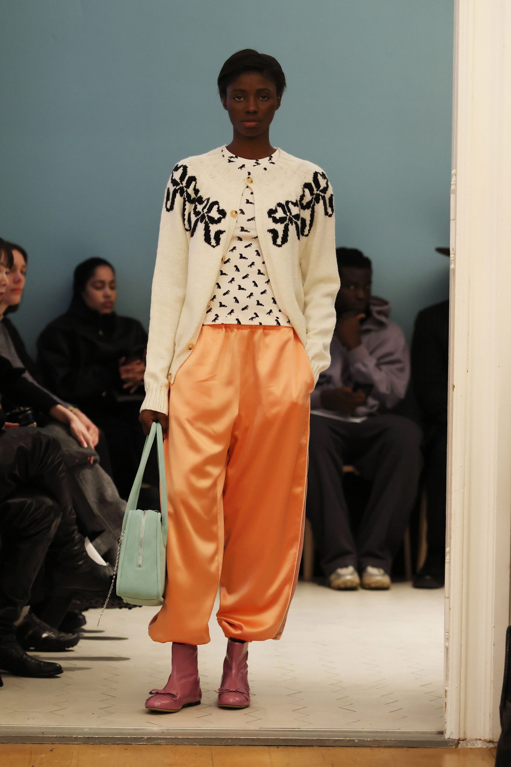 white embroidered cardigan with orange pants